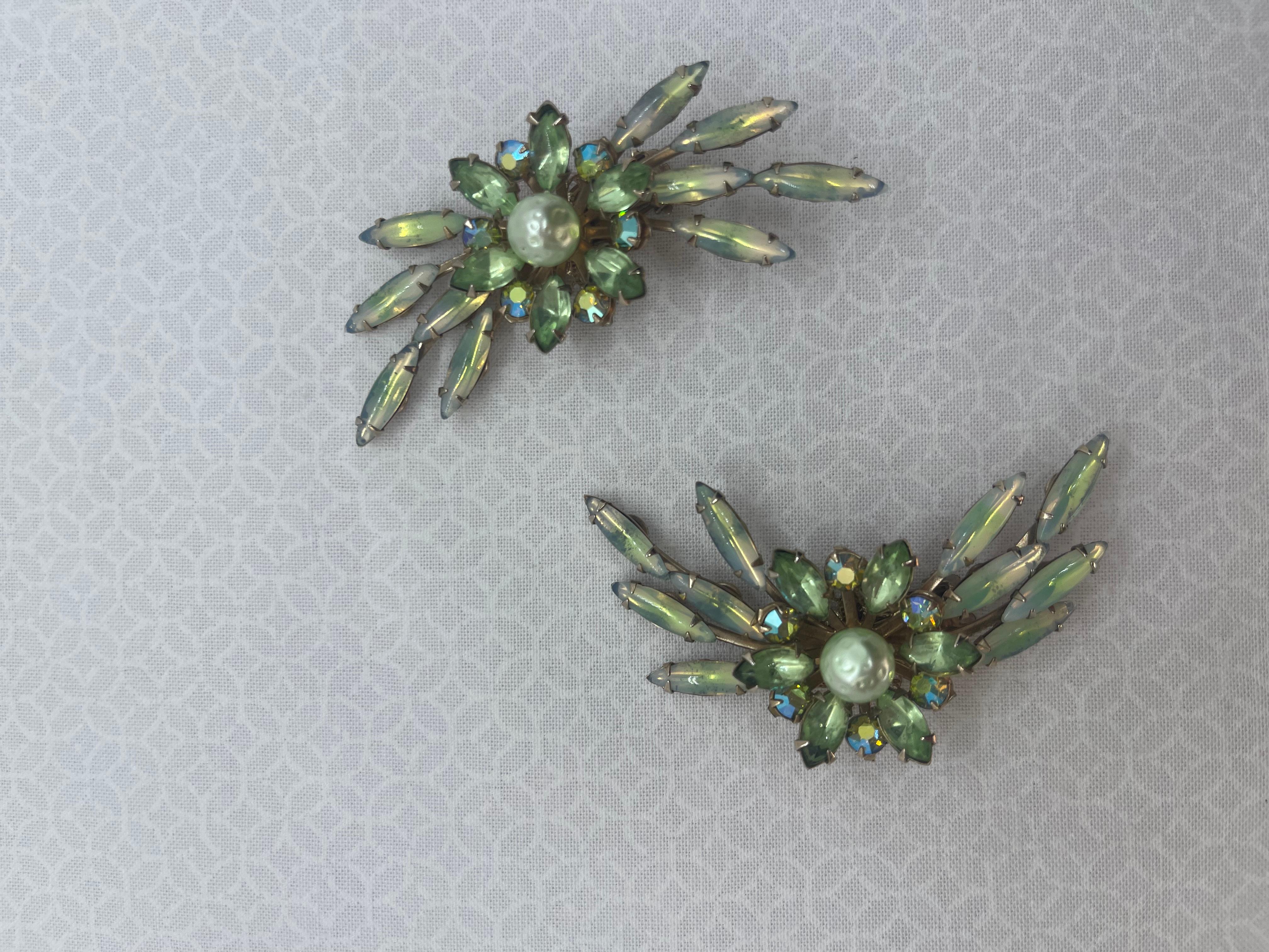 Knock 'em dead is the statement these beautiful one-of-a-kind earrings make. The aurora borealis shimmer and shine in this elegant mint green color.  There is a mixed cut of both round and marquise cut aurora borealis.

These earrings have so much