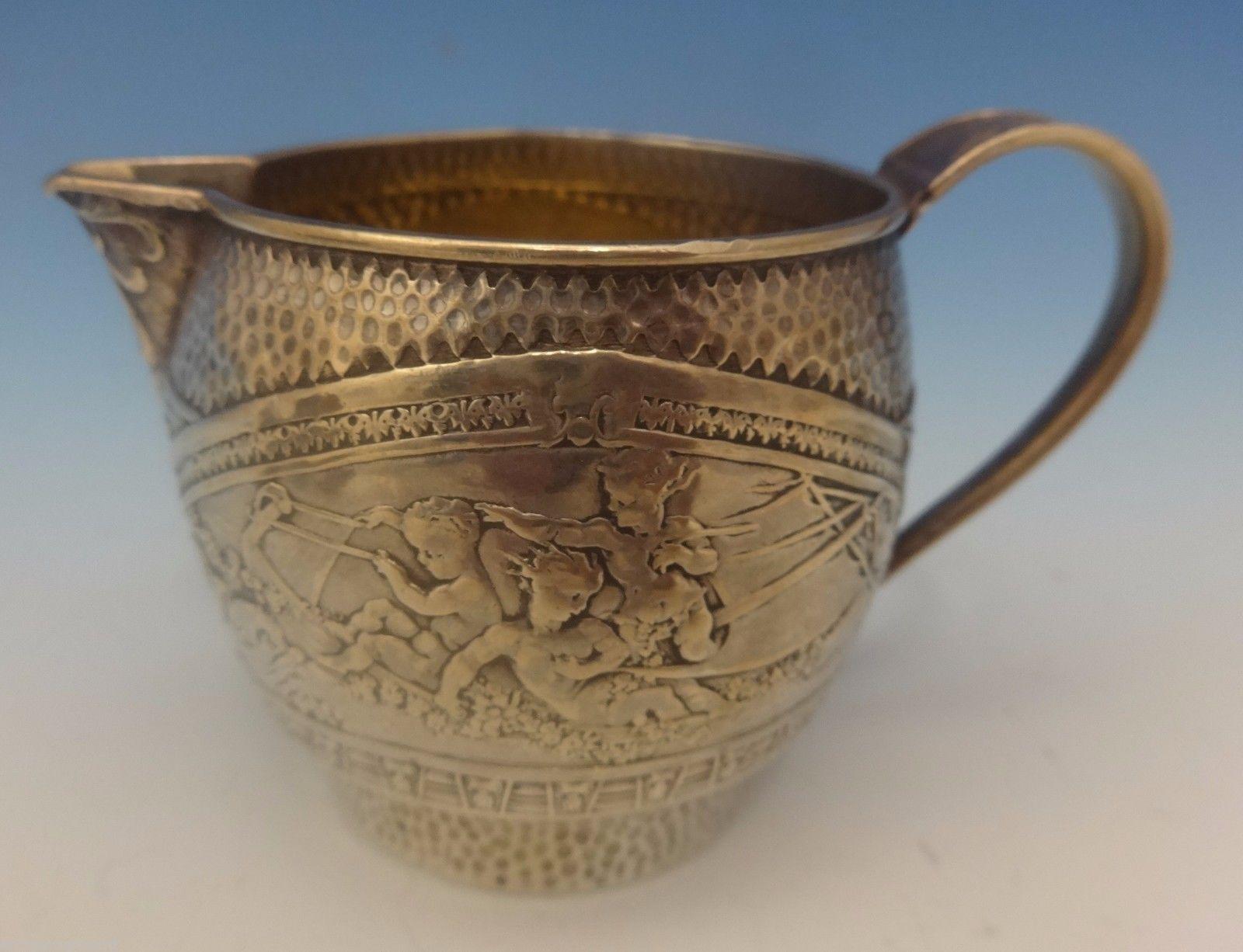 Aurora by Gorham
Gorham sterling sugar bowl and creamer in the pattern Aurora patented in 1870 featuring three figural putti/cherubs in a boat. The pieces are marked with #2275 and date letter M for 1880. The sugar bowl has a swing handle and has