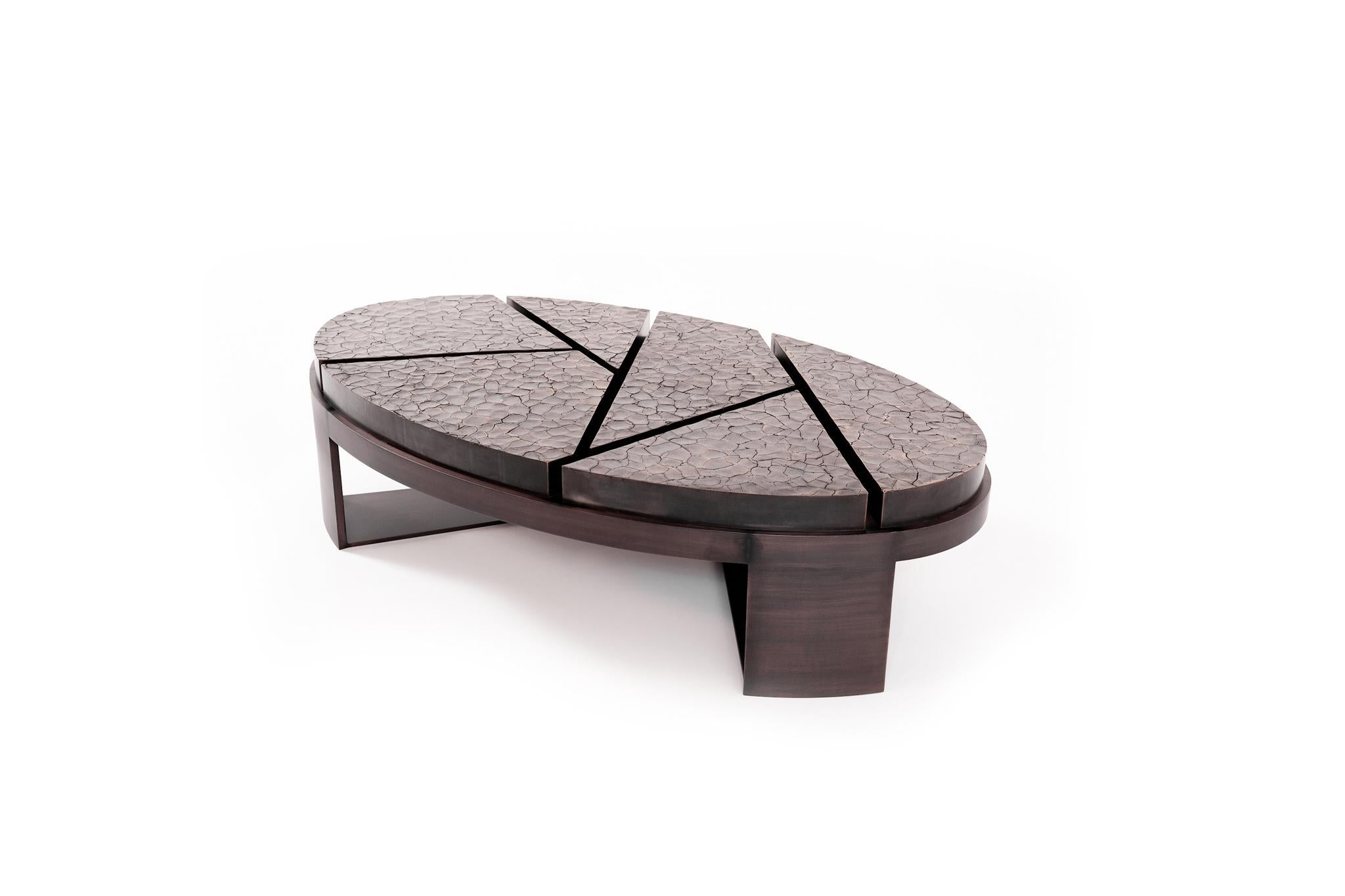 The Aurora coffee table was the very first piece created by FBC London and, therefore, very dear to Fiona's heart.

Its geometric base and laser cut surface immediately grab the eye, whilst the Cracked Earth finish rippling across the top ensures