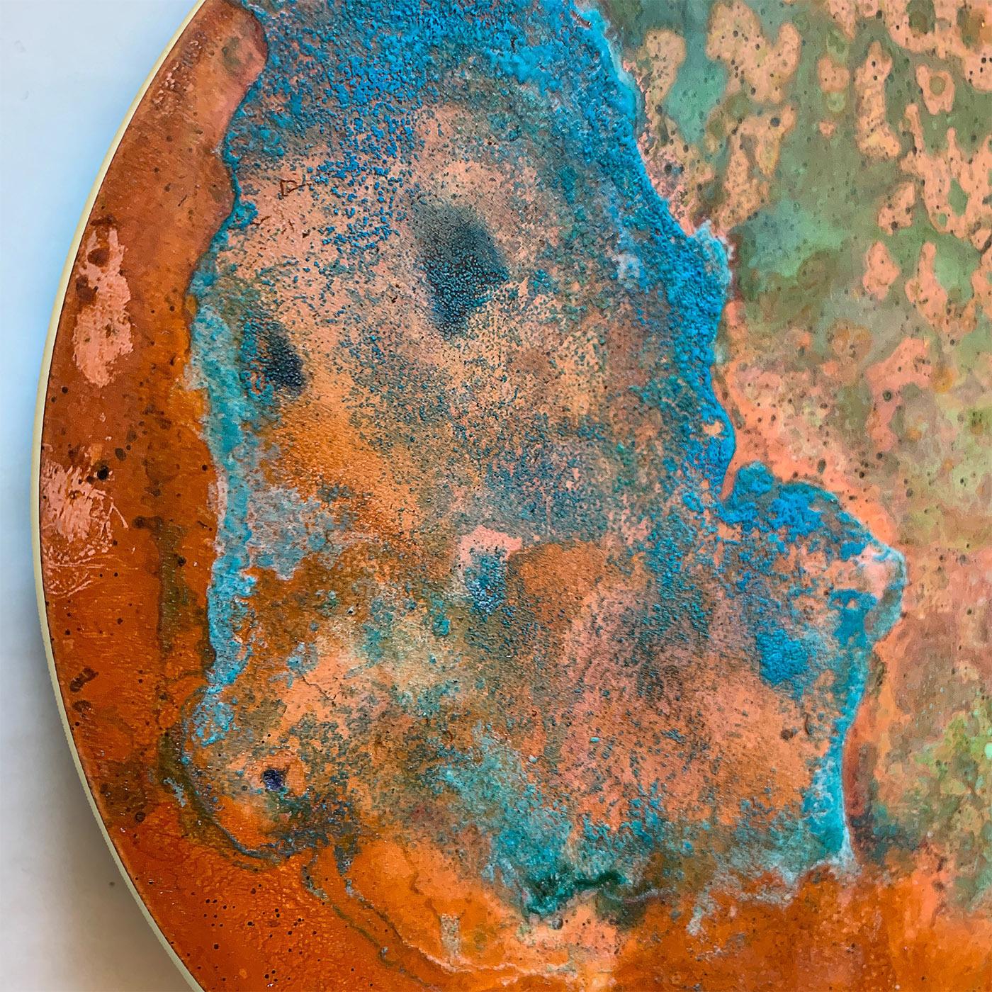Deliberately corroded and decorated with oxides to achieve its unreplicable traceries and shades, this decorative disk from the Aurora Collection is carefully handcrafted with sunrises in mind. Warm and cool tones blend in a breathtaking design that