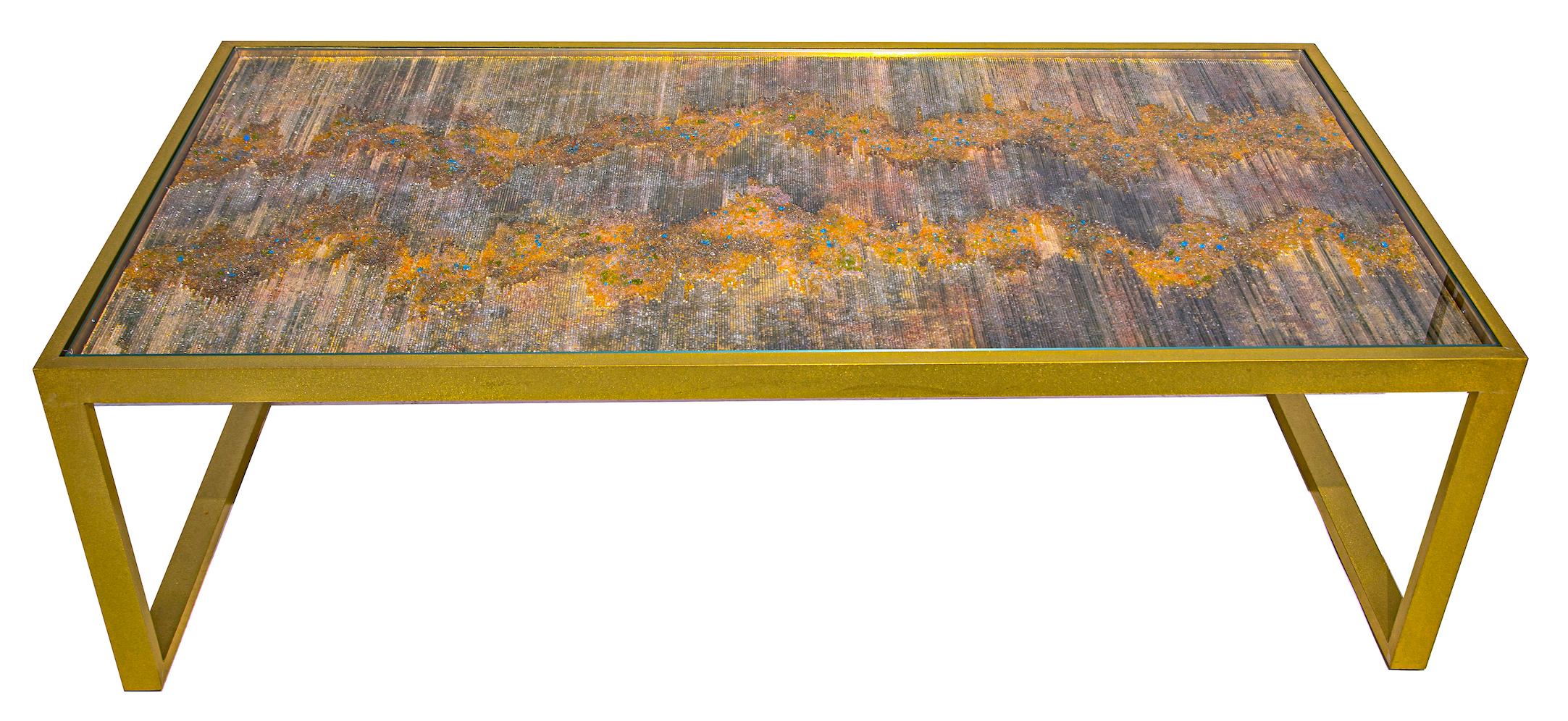 “AURORA” is a one-of-a-kind coffee-table, designed and manufactured by KalaRara. The tabletop realised on an aluminium sheet covered in gold, silver and copper leaf overlaid with Murano glass rods with insets of crushed Murano glass and acrylic. The