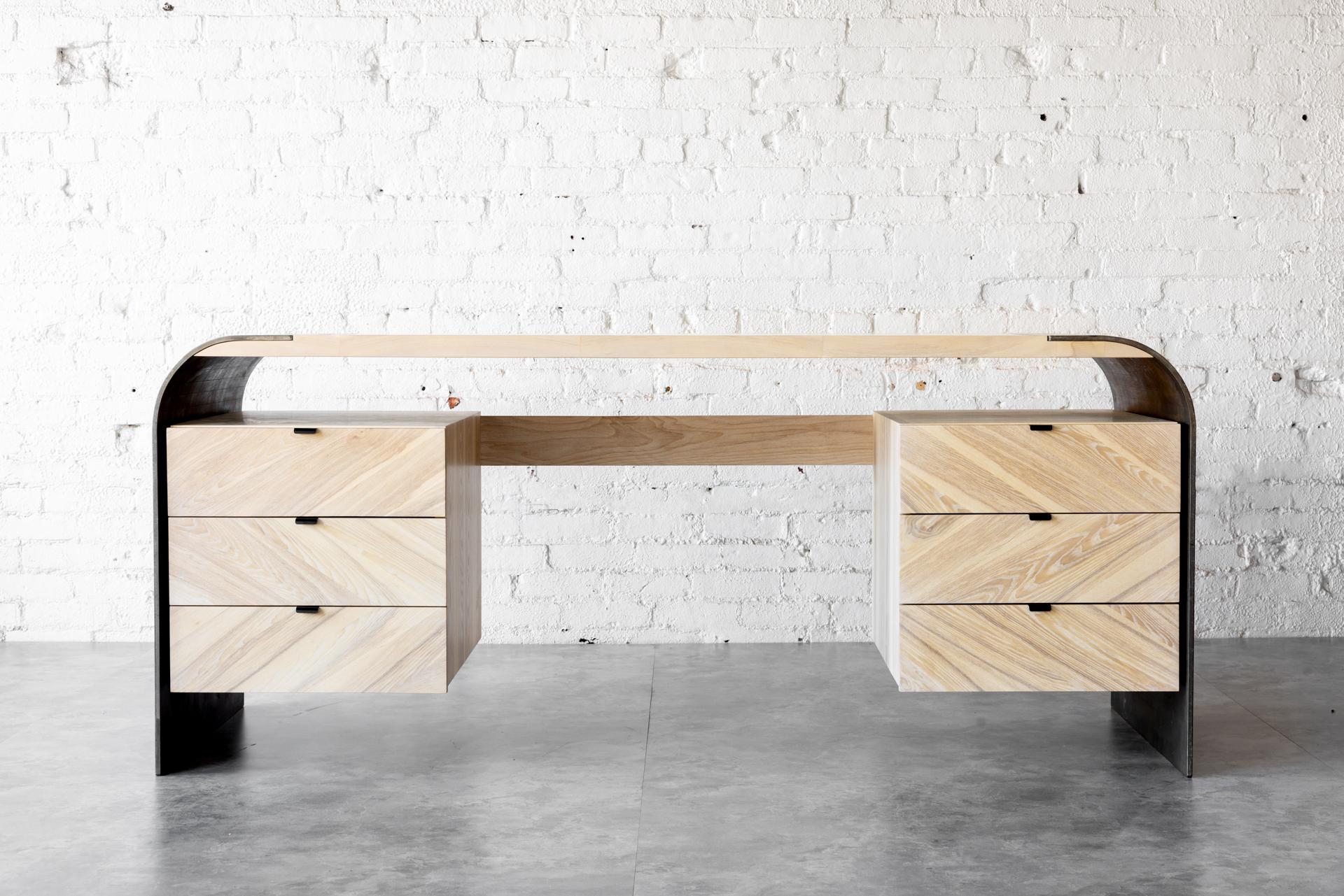 Elevate your workspace with the stunning Aurora Desk from Autonomous Furniture. Crafted from the finest Whitened Ash wood and raw steel, this modern industrial desk is a true statement piece for any home or office. The unique herringbone pattern on