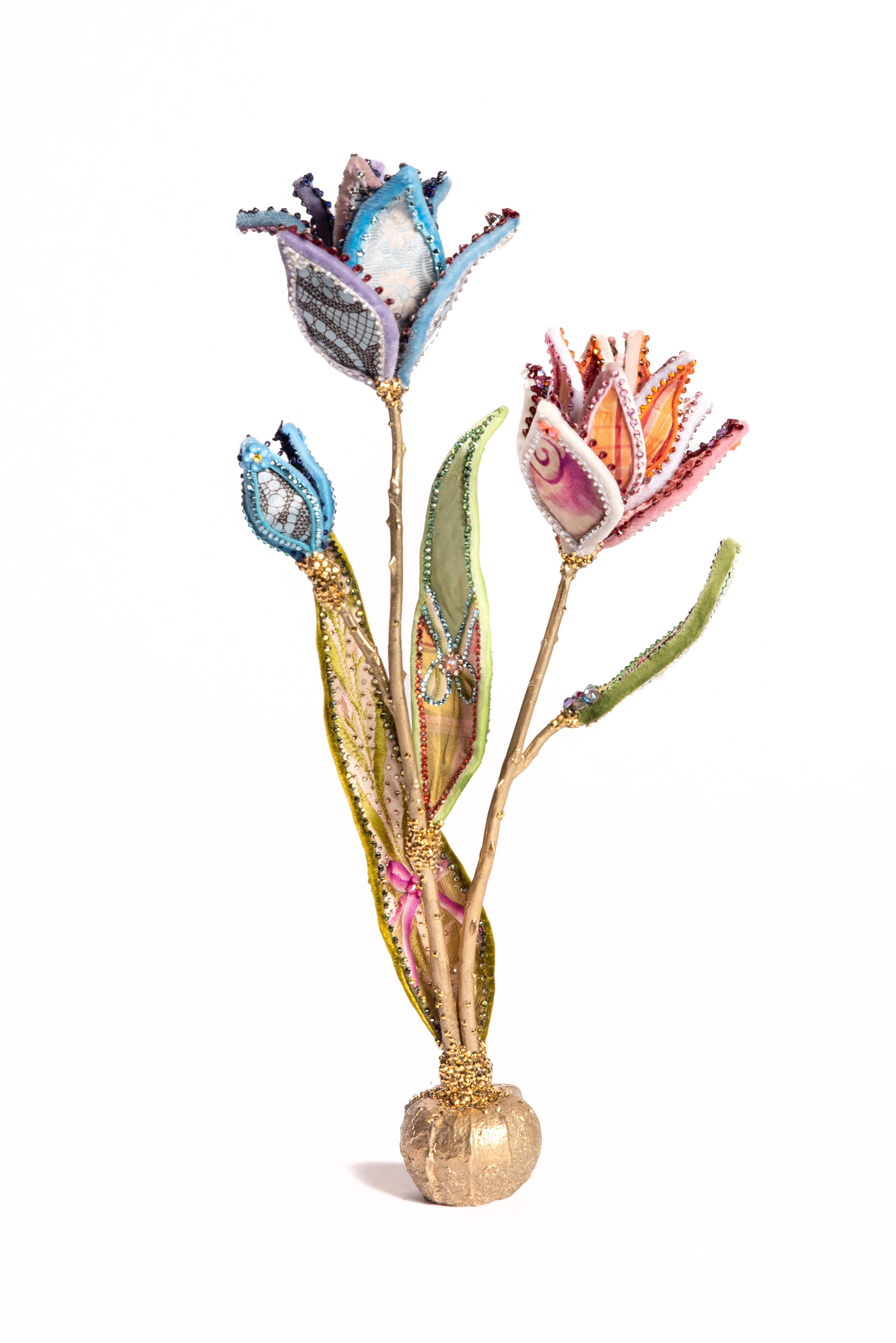Blue & Orange Tulip in silk and velvet resting upon a bulb-shaped brass base. Exceptionally detailed leaves feature one-of-a-kind designs on each piece. Adorned with vintage millinery embellishments, European crystals, and vintage faux-stamen.