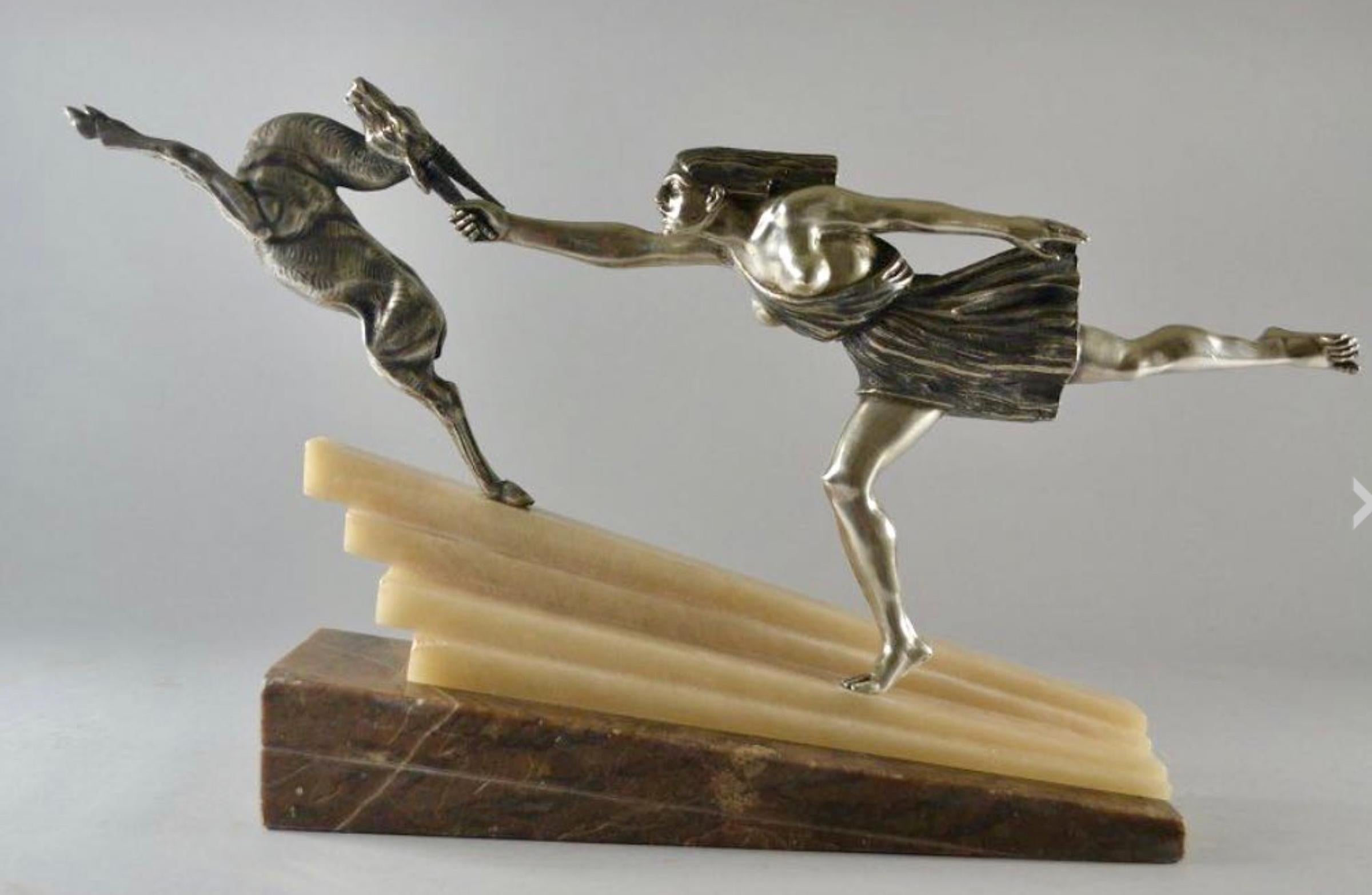 Silvered Bronze Art Deco Statue Pair featuring a woman reaching and grasping the antlers of a deer, a rare version of “Chasing the Hind” Designed by Aurore Onu French circa 1930. It has an outstanding classic and cubist design, with a female figure