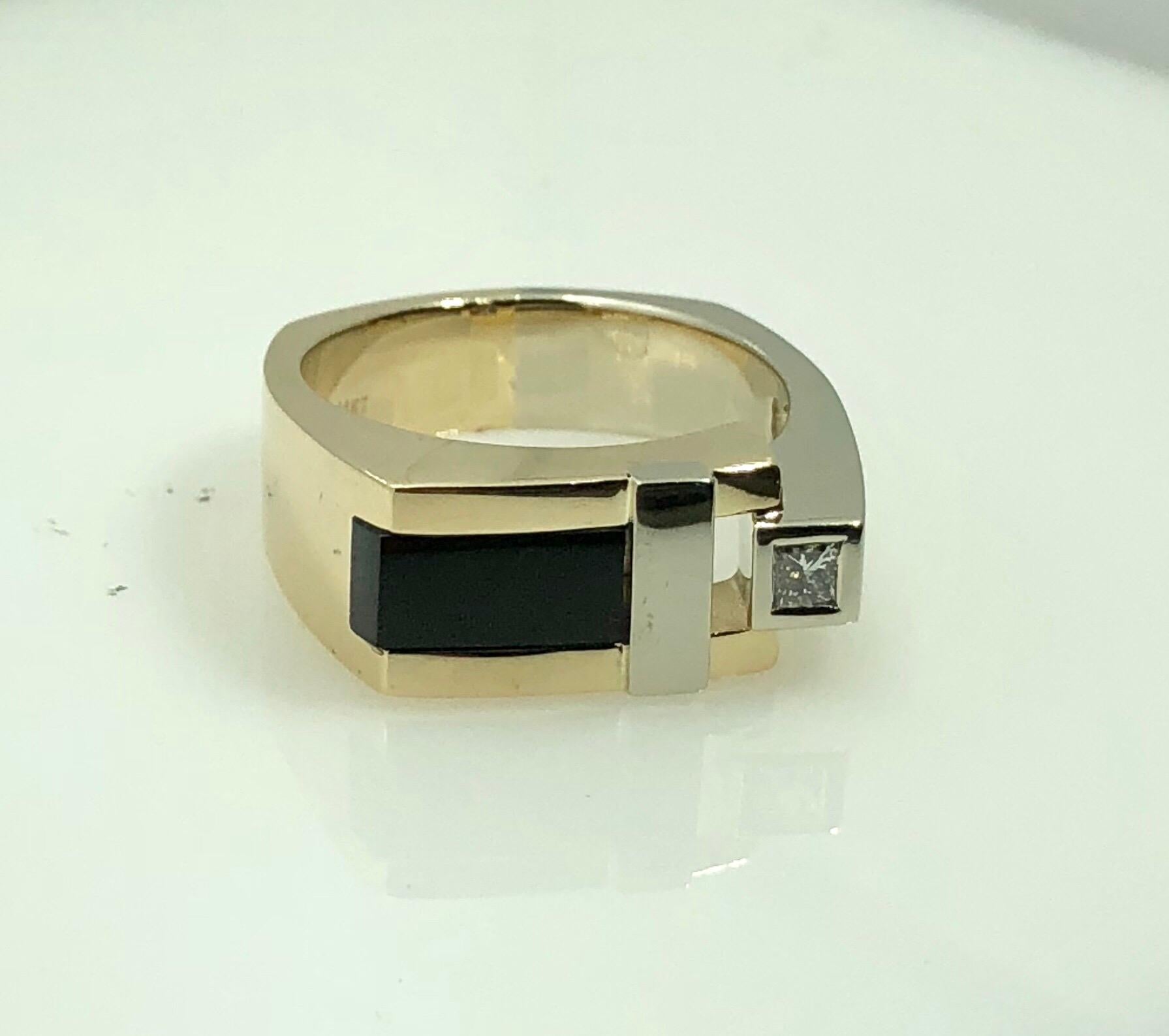 Aurum 14 Karat Two Tone Diamond and Onyx Contemporary Ring. This piece is technically a Mens ring but would be stunning as a womens piece as well. Original Aurum  creation, created in 14 karat yellow and white gold, weight 14.3 grams. Adorned with