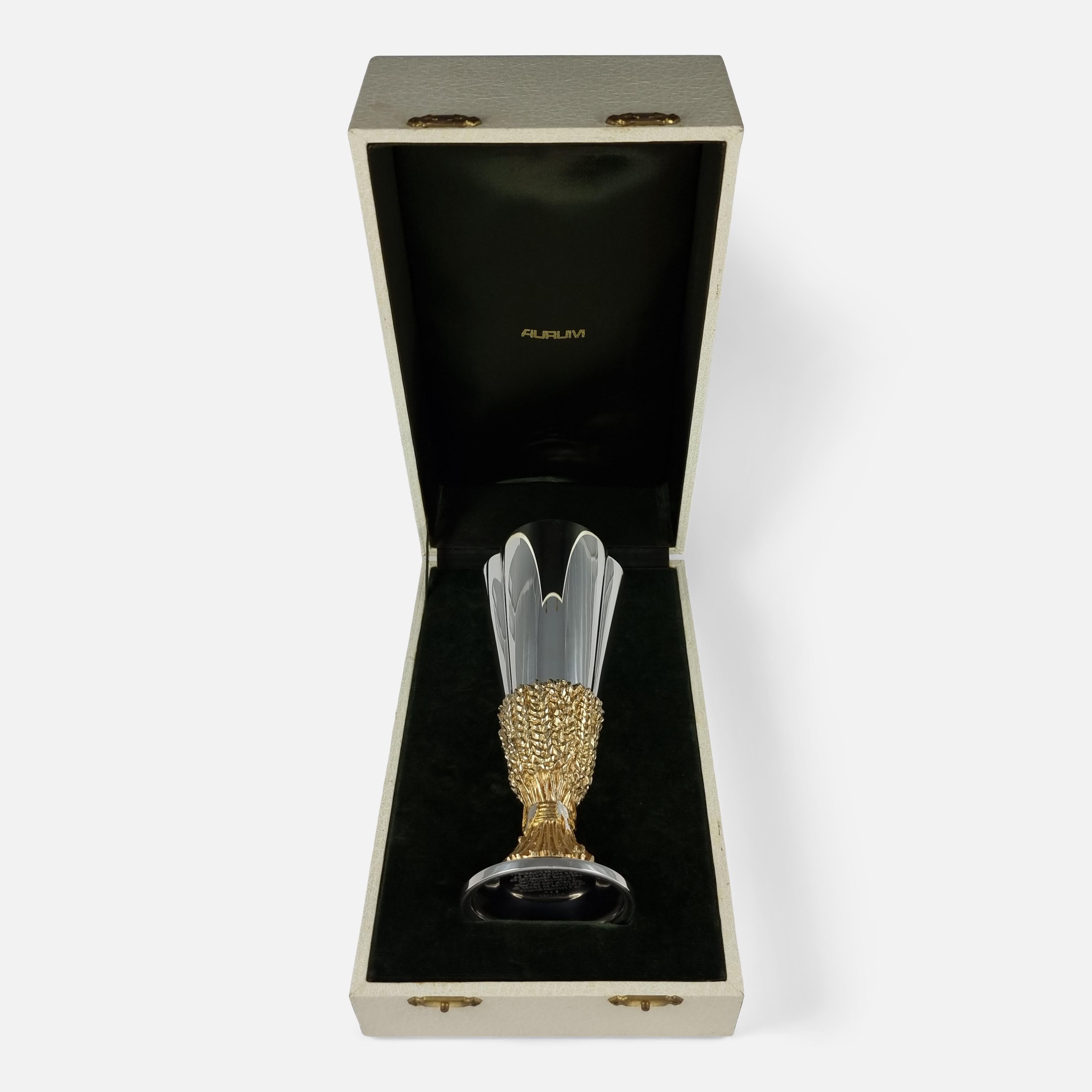 An Elizabeth II Parcel-Gilt Silver Goblet, by Desmond Clen-Murphy for Aurum, London, 1976. It is numbered 304 from a limited edition of 600. The goblet is of tapering trefoil form, the foot cast as wheat sheafs, complete with a band of various