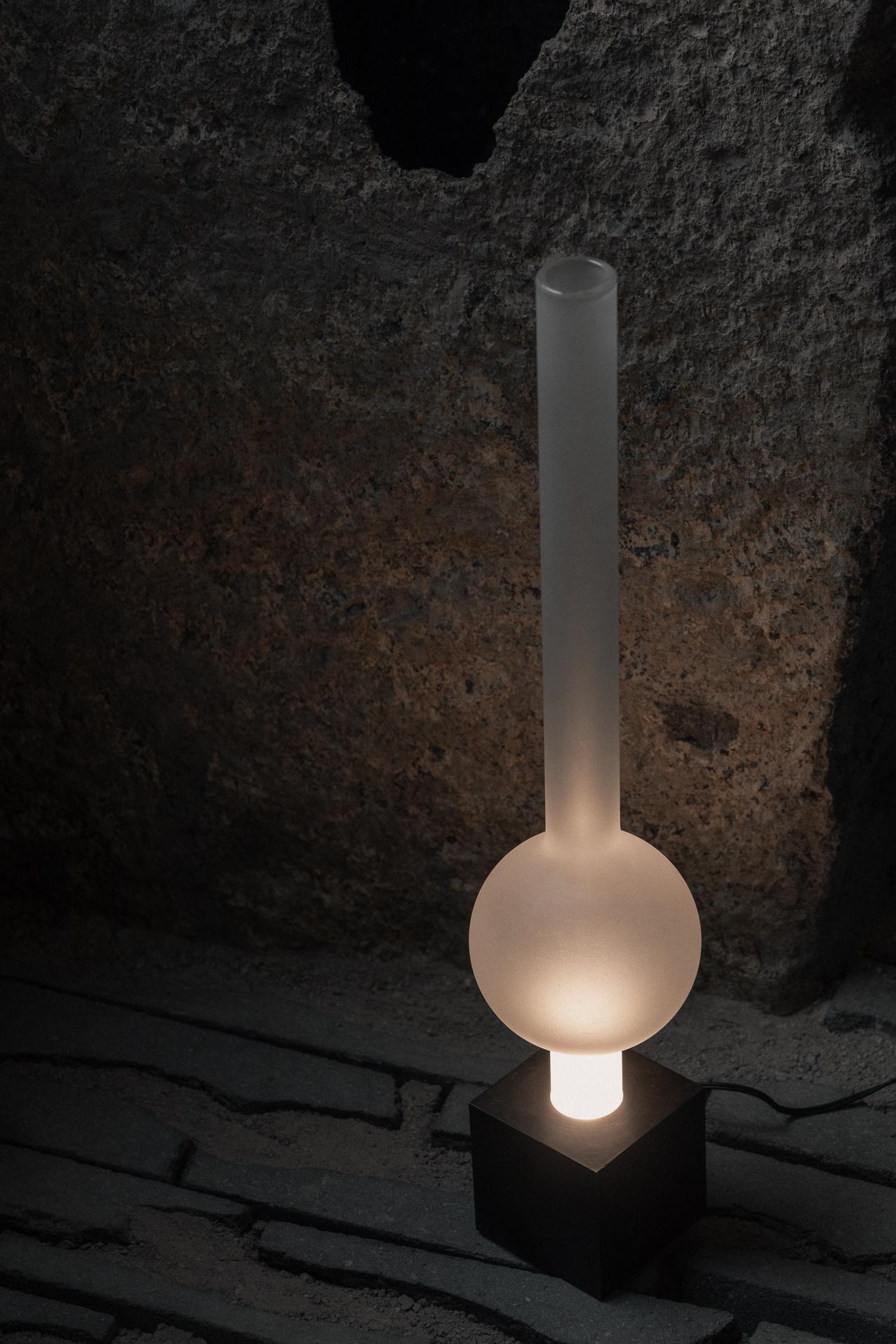 Aurum Table Lamp with Round Base & Long Glass Sphere Shade by Nuumbra
Dimensions: Ø 7,6 x H 45 cm. 
Materials: Frosted glass and aged brass.

Available in blackened steel and frosted or clear glass, or in aged brass and frosted or clear glass.