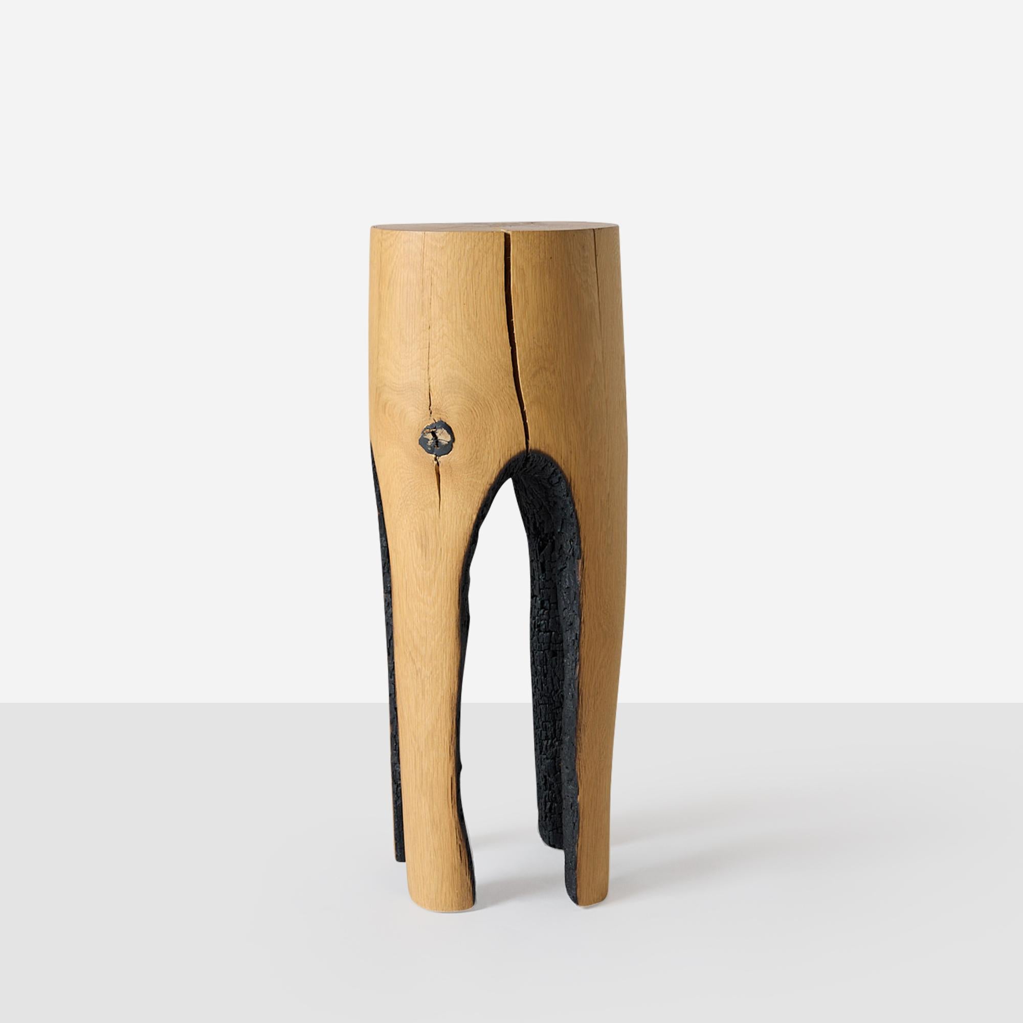 A stool formed by the hollowing out of oak tree trunks using fire. The oak comes from naturally fallen trees and all are made by the Belgian artist Kaspar Hamacher