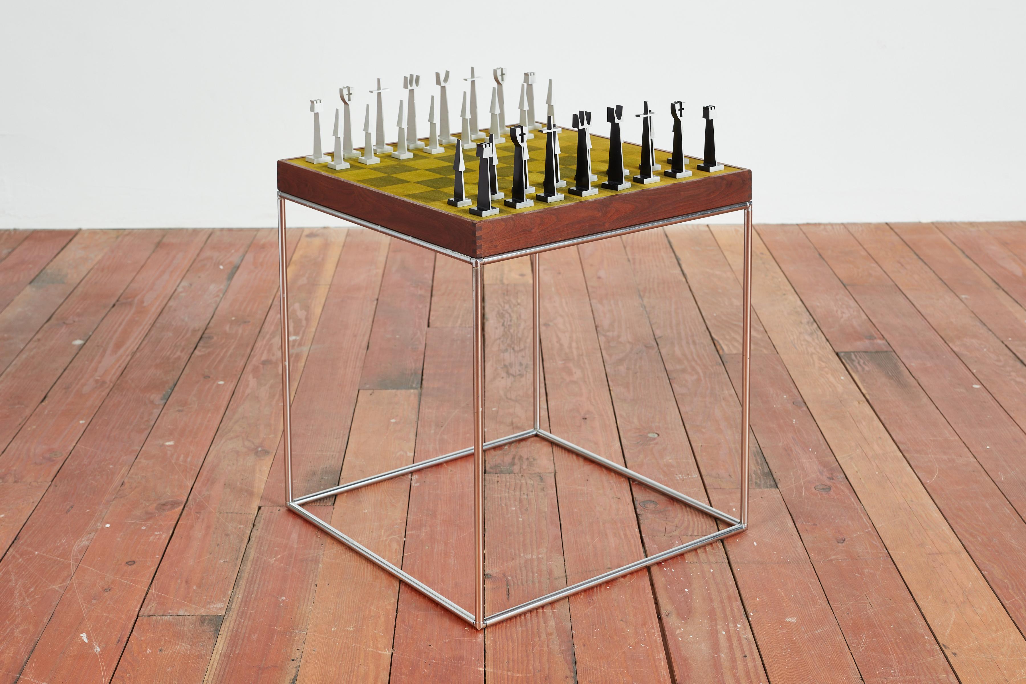 A rare Austin Cox chess set on chrome base with walnut trim and printed green velvet board -  by Austin Cox. 
Set comes with original box with wonderful vintage aluminum chess pieces 
1966, Austin Enterprises 
Each piece and table marked 

Table: