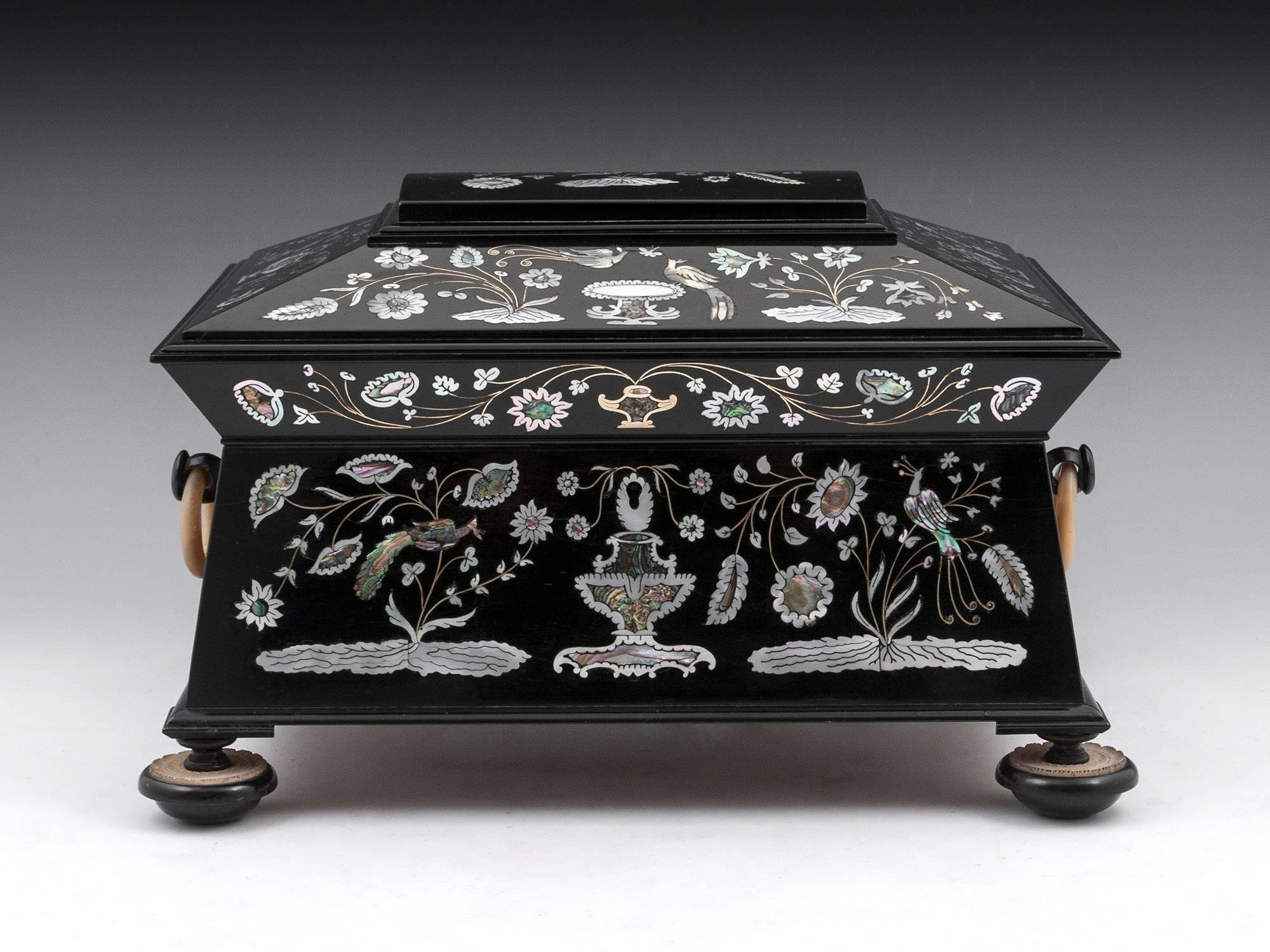 A fabulous sewing box attributed to Austin of Dublin with intricate mother-of-pearl and abalone and brass wire inlays of flowering branches, exotic birds and jardinières. Fitted with solid mother of pearl ring handles and standing on elaborate