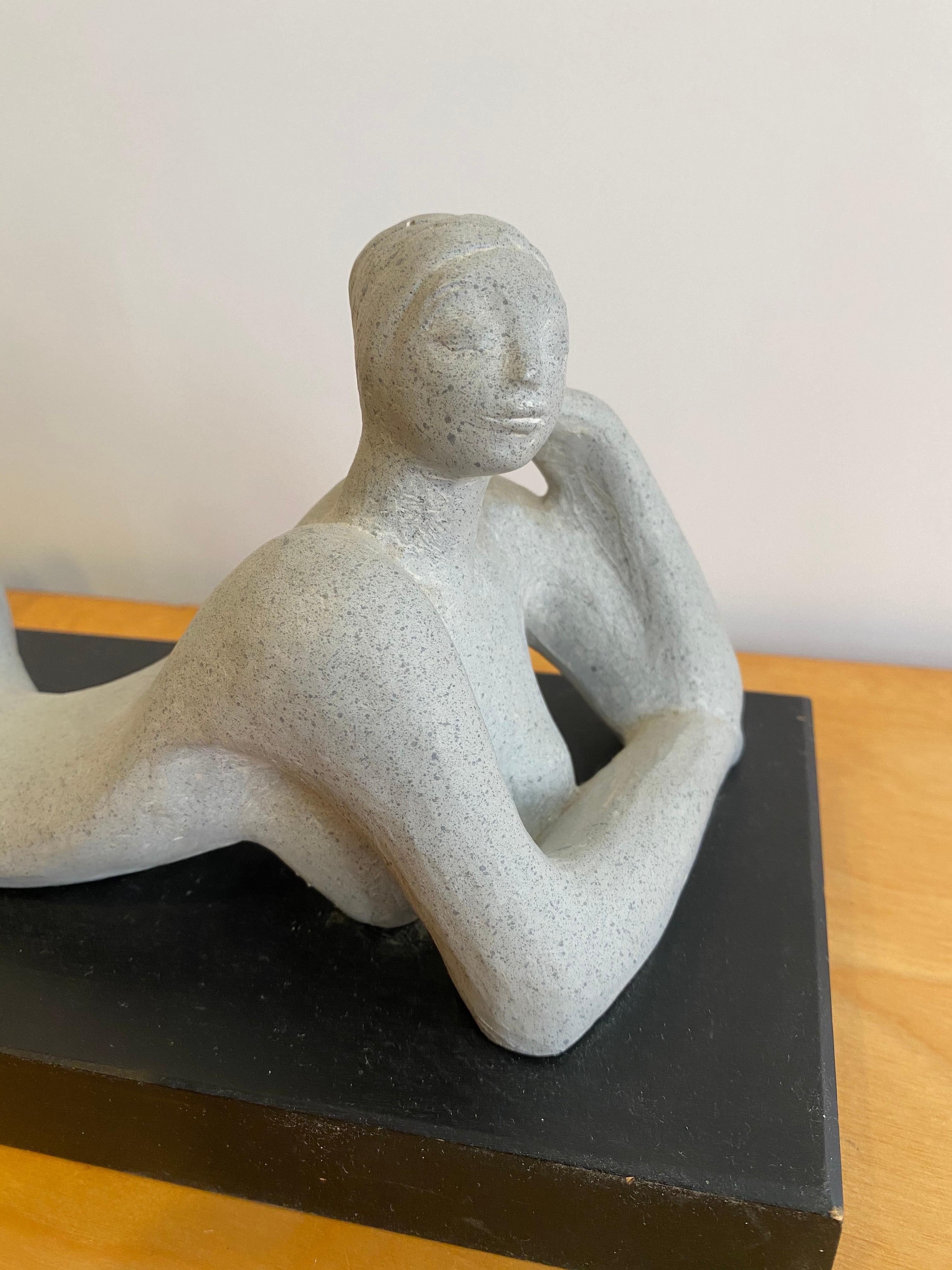 Austin Productions reclining nude. Plaster sitting on a black wood base. Signed and dated 1978.