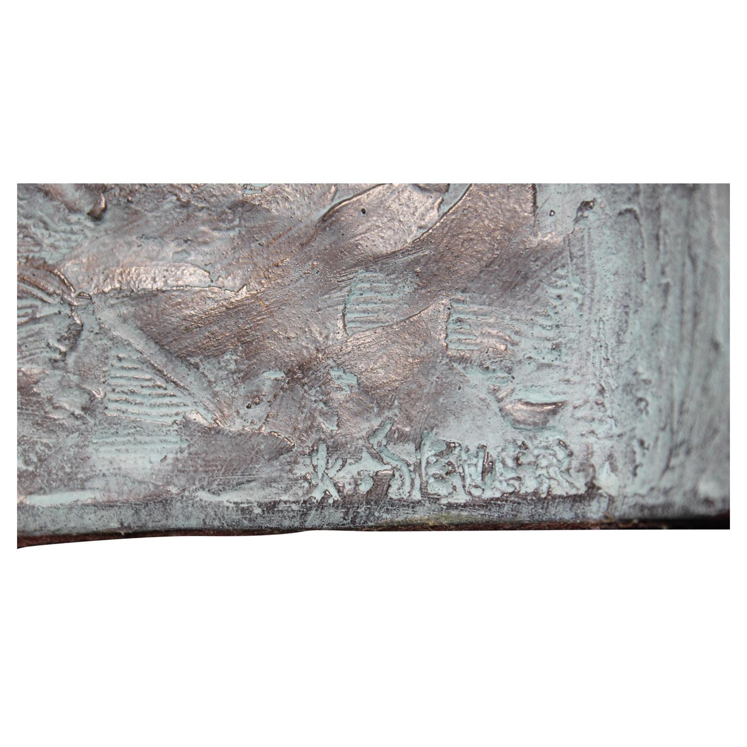 Two girls seated on either side of the bench looking at each other. The bronze is signed and dated by the artist K. Sevar. The bronze was produced by Austin Productions.