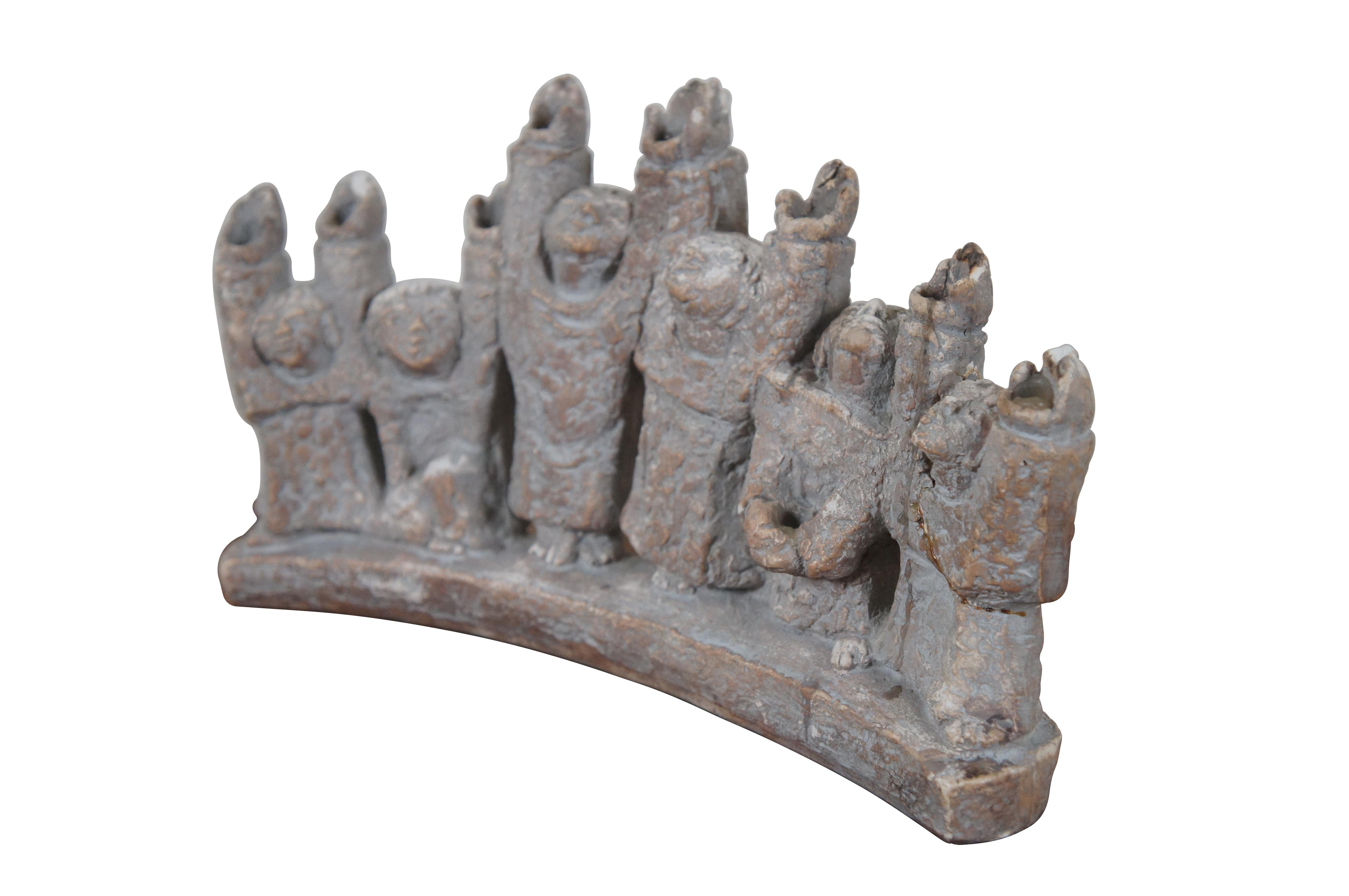 Vintage 1965 ceramic brutalist Durastone Hanukkah menorah produced by Austin Products Inc (designed by Ellen Lord),  shaped by 6 human figures (Maccabees) standing in an arch, their arms and faces raised up. Candles sit in the