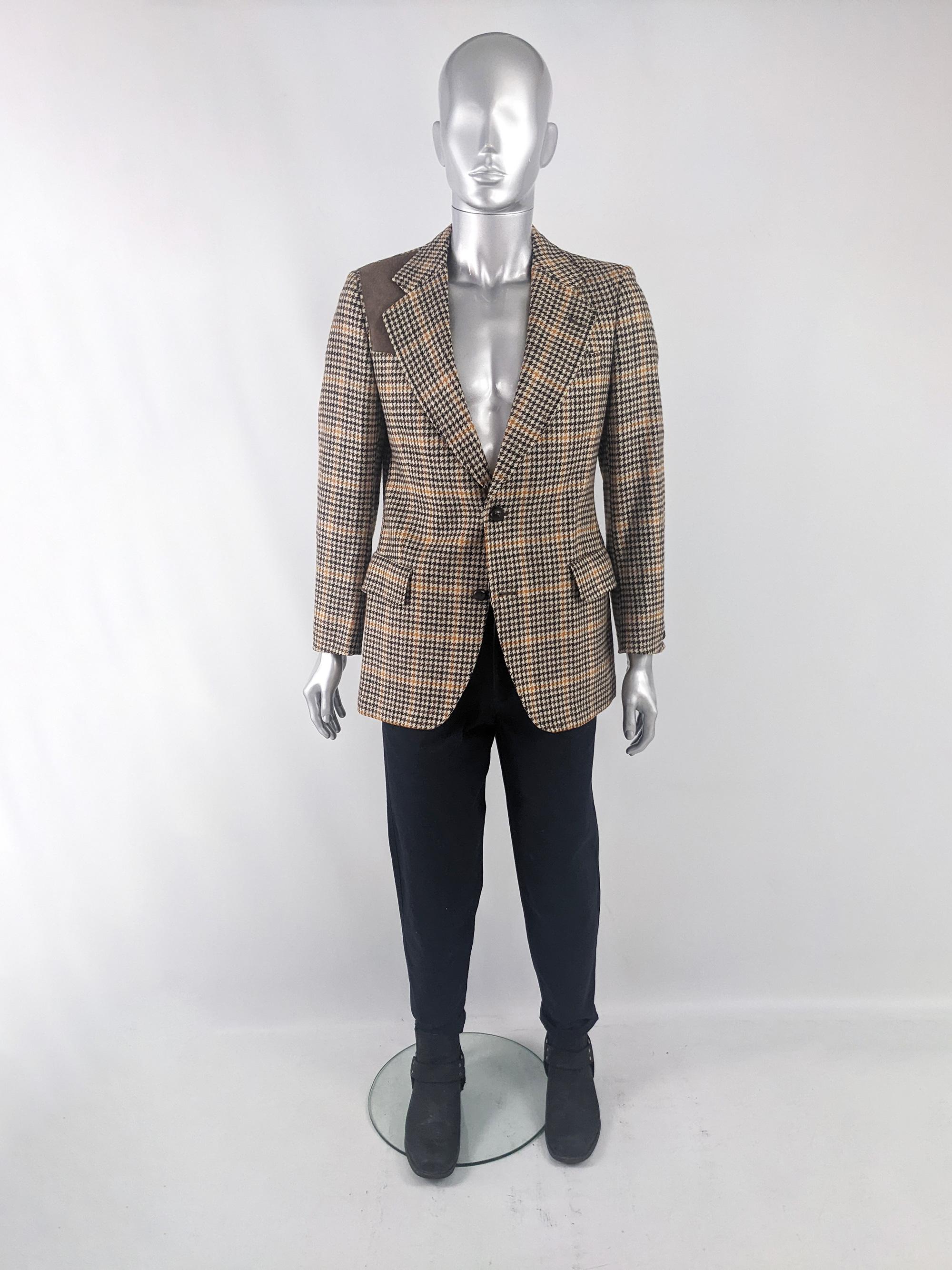 A stylish vintage mens tweed blazer jacket from the 70s by British label, Austin Reed. In a Manx tweed (from a rare breed of sheep on the Isle of Man) with a suede patch on the shoulder. It has single breasted buttons and a double vent to the