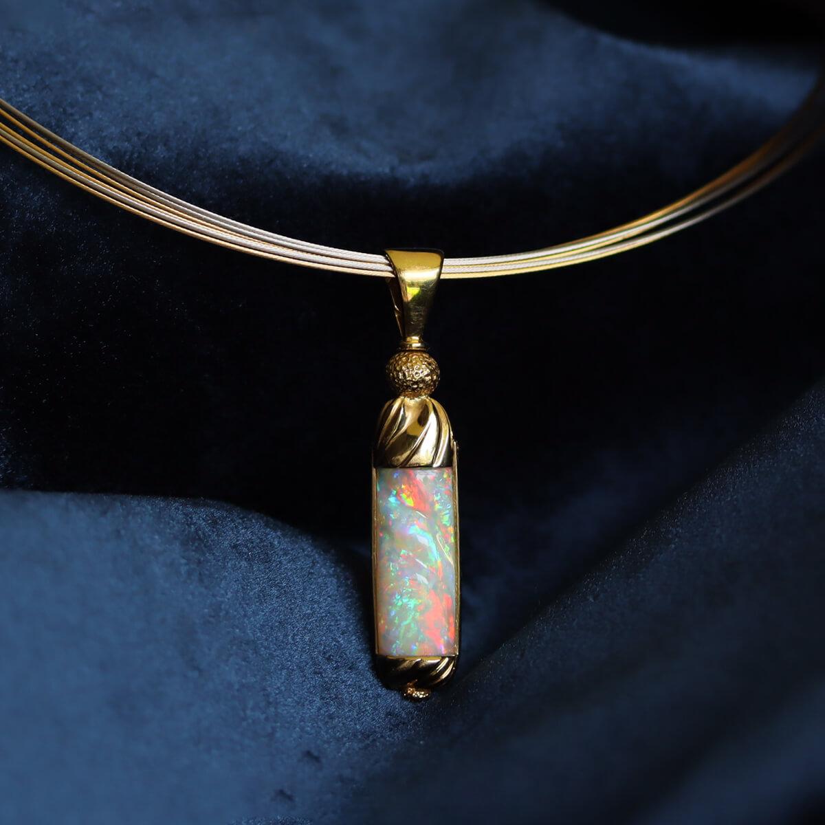 What a charm of light. Not only is this a stunning solid 18K gold pendant but the beautiful Light Opal is also a fossil. This opal is a belemnite, an ancient sea creature similar to a cuttlefish that had a round bone in its back and some of these