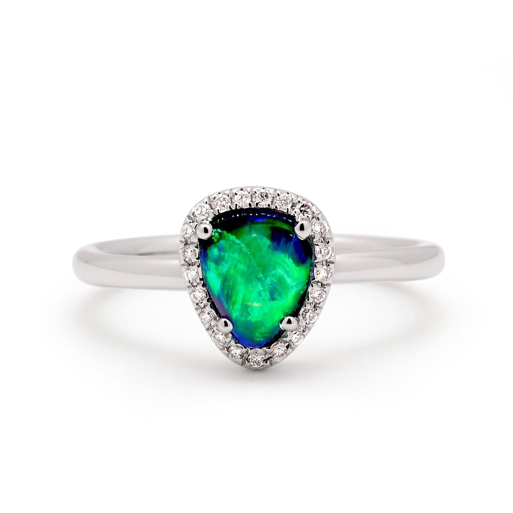 A delightful black opal (1.23ct) with astounding colour-play is the heart of “Marta” opal ring. The 18K white gold setting with its frame of sparkling diamonds make this a classic yet unusual engagement ring. Utterly irresistible – she’s bound to