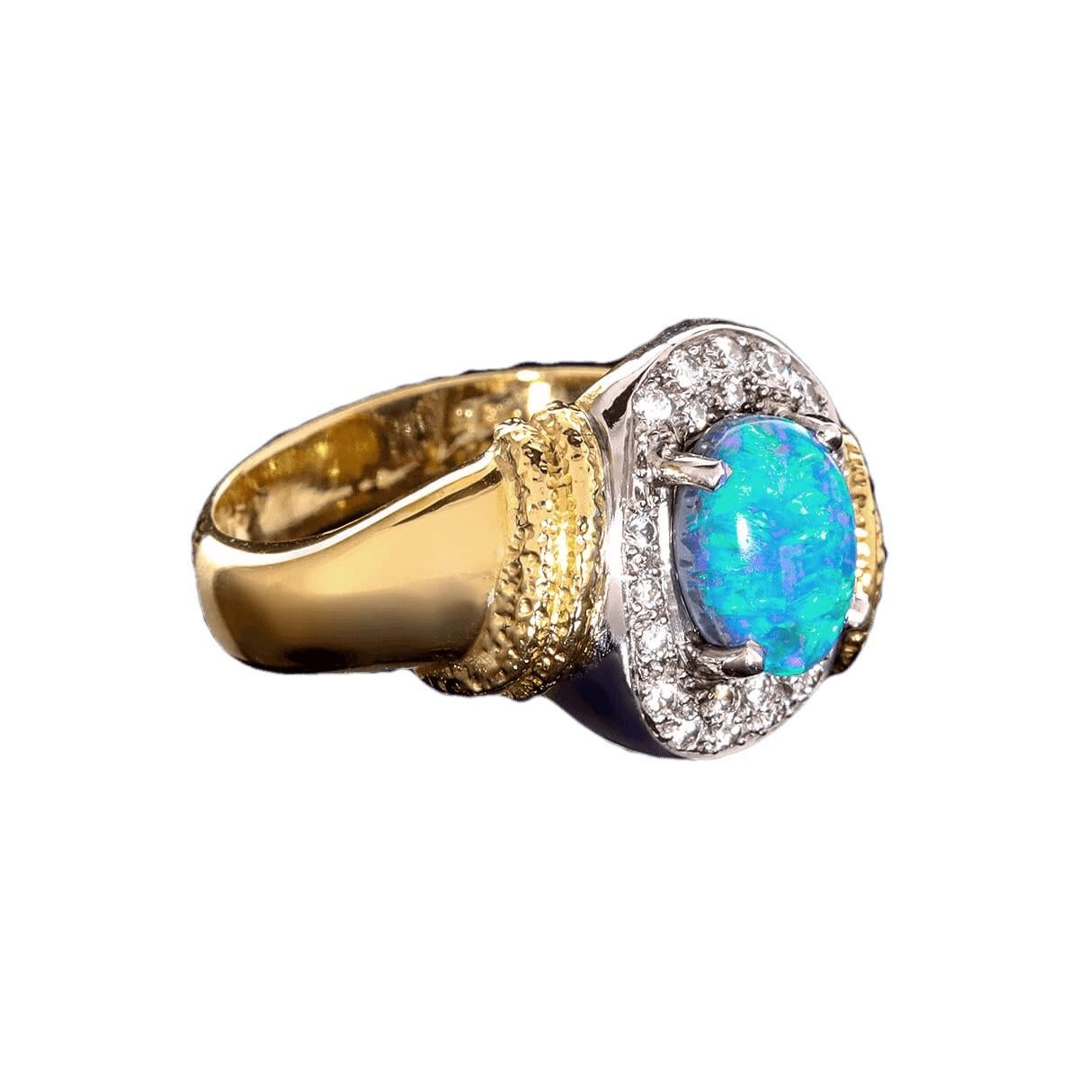 To say this stone is vivid is an understatement. The blue and greens are so intense you will find yourself lost in their beauty. Solid 18K gold ring with a magnificent blue-green solid Australian Black Opal, surrounded by brilliant white diamonds