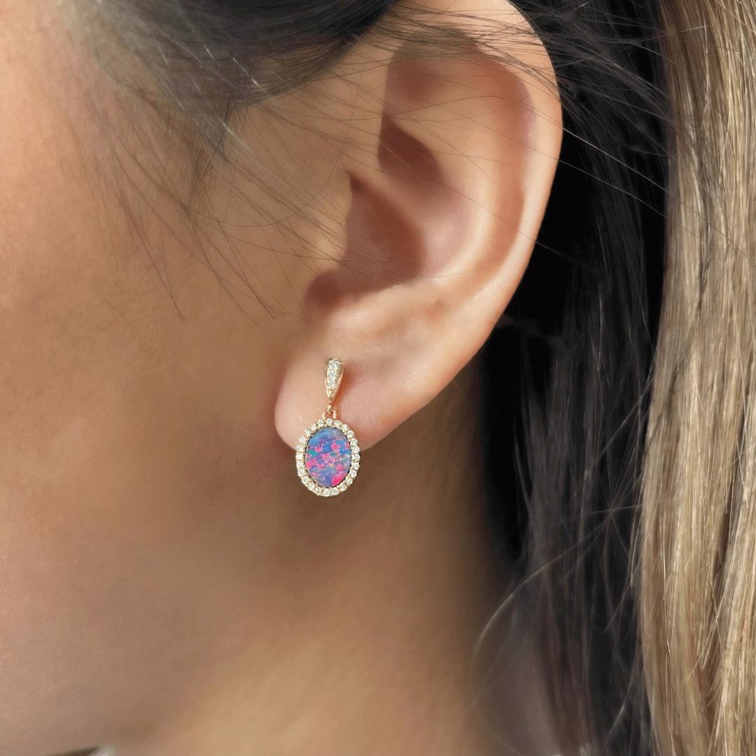 Enthralling and sophisticated is the wearer of the ‘Rhapsody’ opal earrings (1.35ct) set in 18k yellow gold and embraced by a dazzling set of fifty-four diamonds. The precious opal gemstone of this piece presents a sought-after blend of red and blue