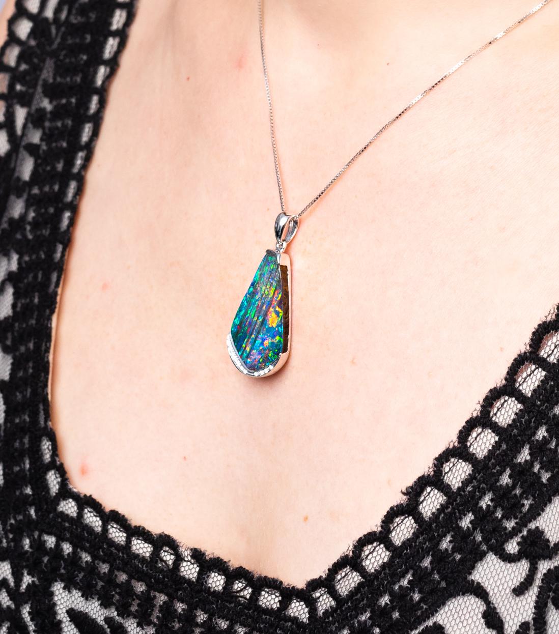 Beguiling and colourful, “Deseo” opal pendant enthrals with its colour-play. This 14.22 carat boulder opal from Winton displays a rare and prized panther pattern. The 18K pure white gold setting and flash of diamonds set off this splendid opal. Un