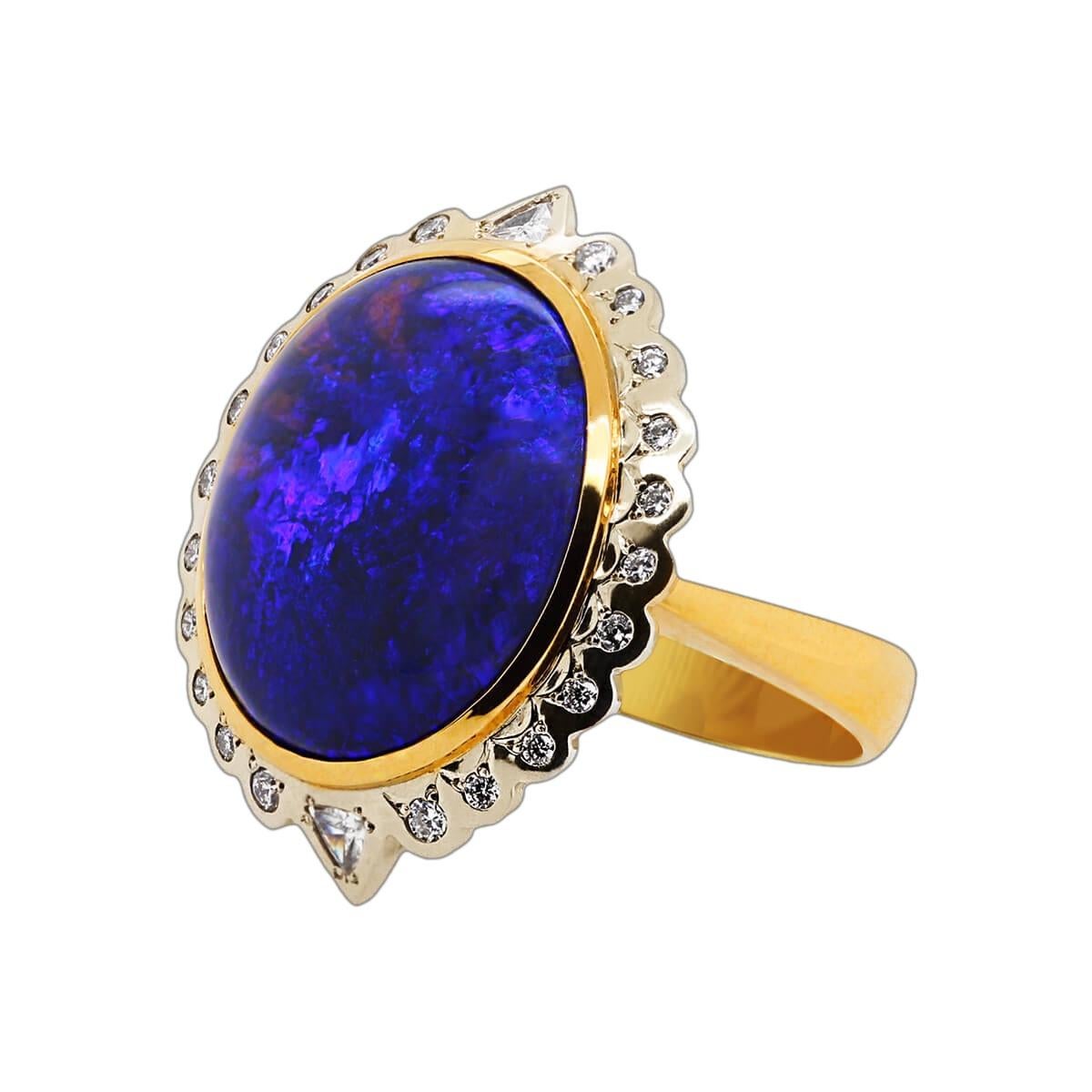 Some rings are cute, others are elegant, but some are meant for a queen. A black opal direct from the mysterious outback of Australia, surrounded by brilliant white diamonds in a platinum and 18K solid gold setting. The ring of elegance awaits you,