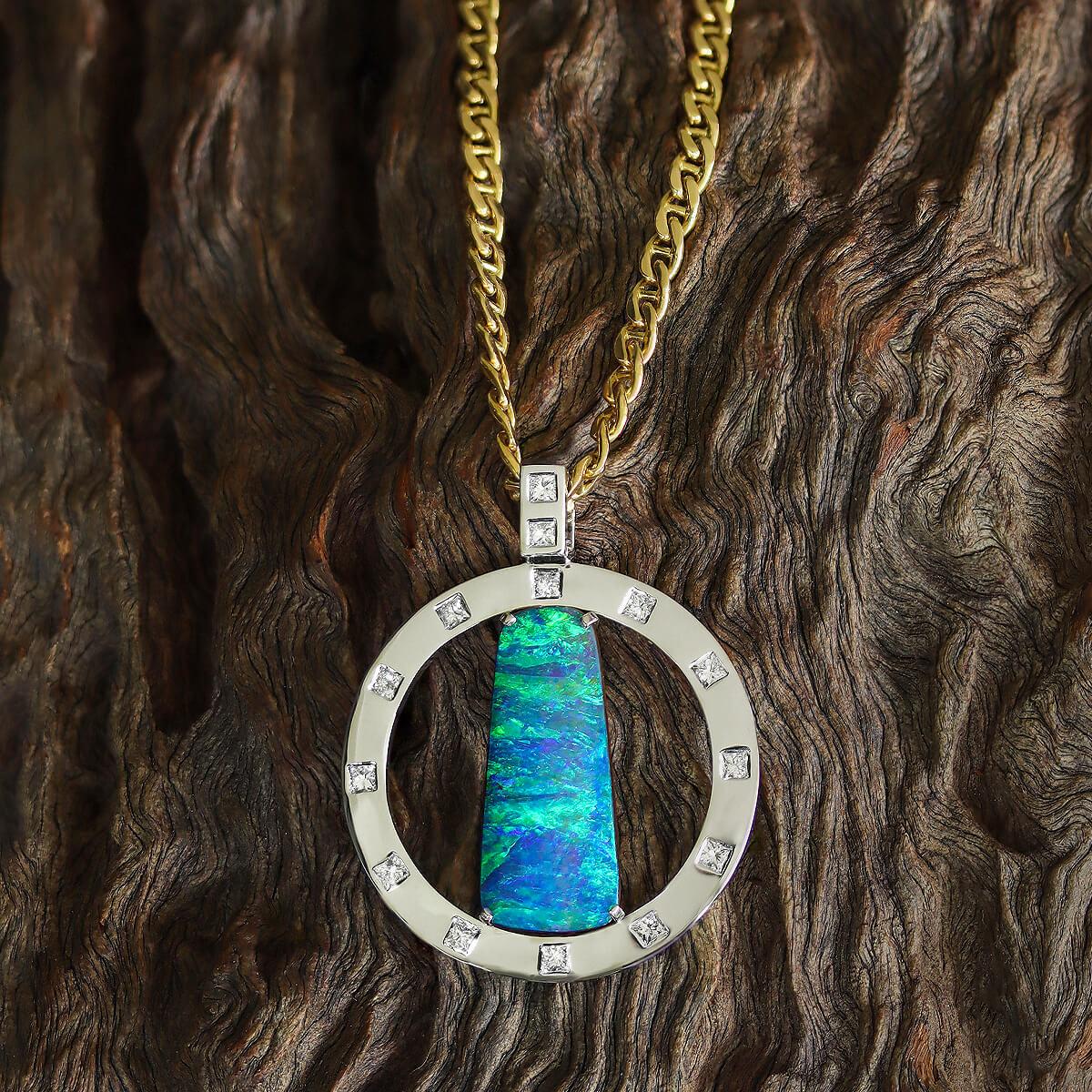 Drawn to this amazing piece? It is hard not to be. A very special blue green boulder opal with intense colour that is always on show. She will take you away to a tropical ocean, with clear blue waters and swaying palms.

The outer ring is solid