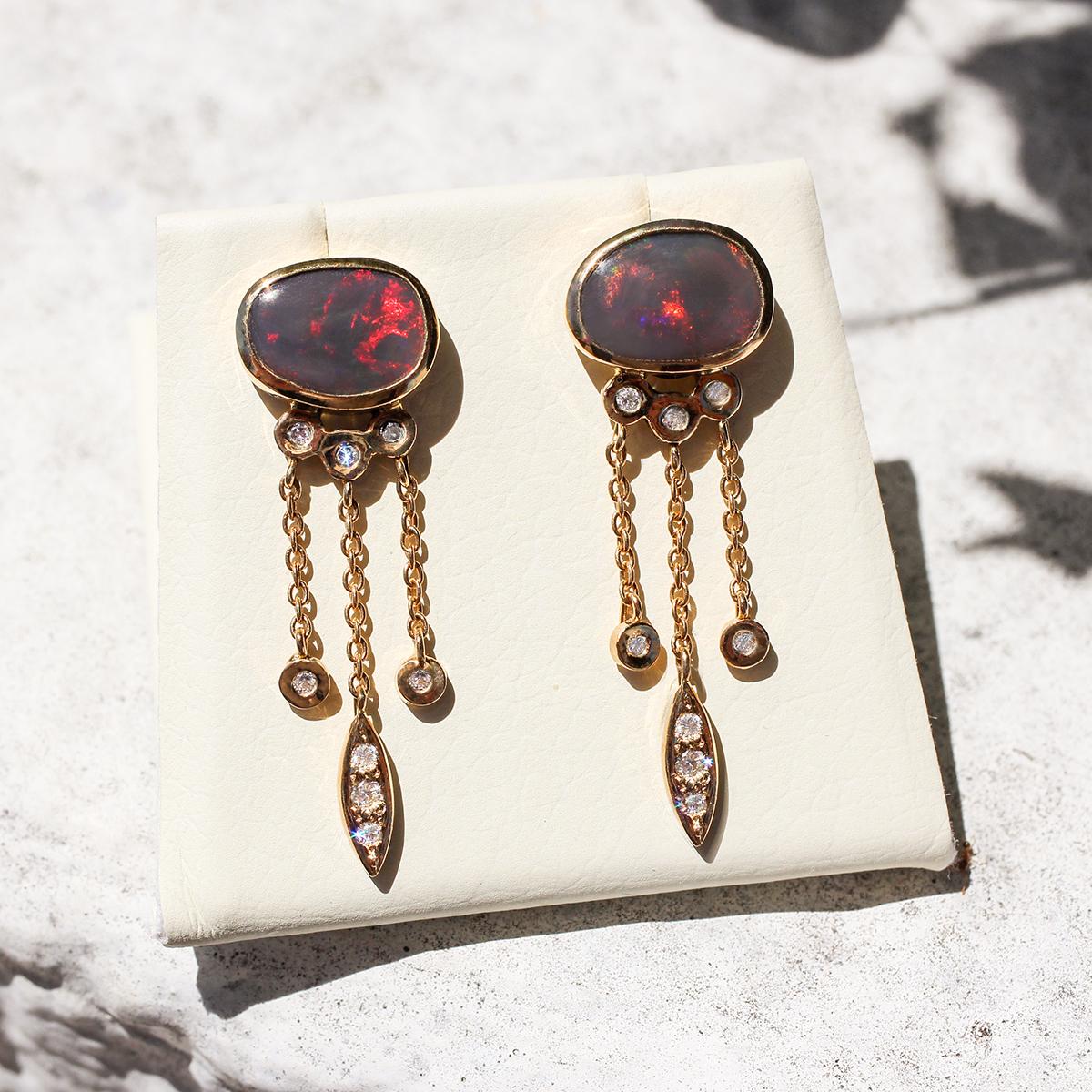 Rare it is to find two black opals that match. These beautiful stones have been cut from the same large opal, giving a matching pair of deep red flashes. Black opal with red is the rarest of all opal, add this to the very cute setting in solid 18K