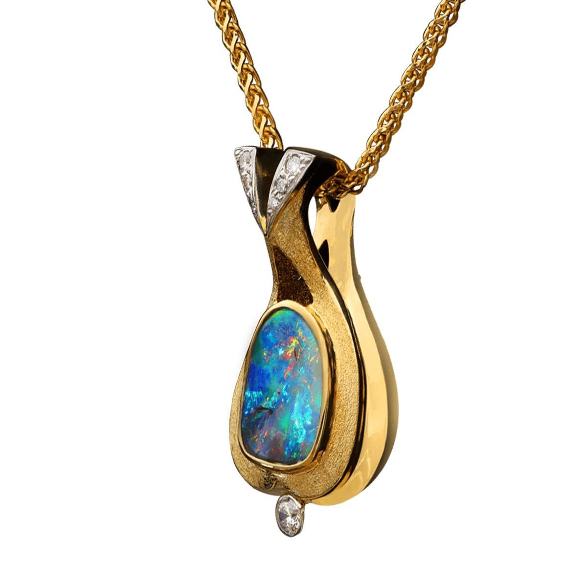 For the lovers of blue-green opals, this gorgeous pendant will surely please. A very bright blue-green Boulder Opal with flicks of orange and gold and hints of purple this stone is truly a gem. Surrounded in 18K solid gold and 7 high jewellery grade