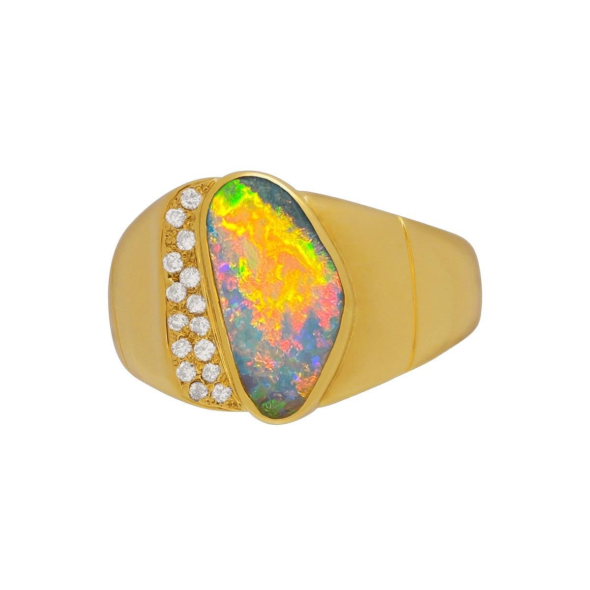 A very unique colour array in this broad flash dark crystal opal ring. Vivid colours jump from golds and pinks to red and orange all while showing a lightning burst of blue and greens. As it rolls a little firework pattern emerges to surprise and
