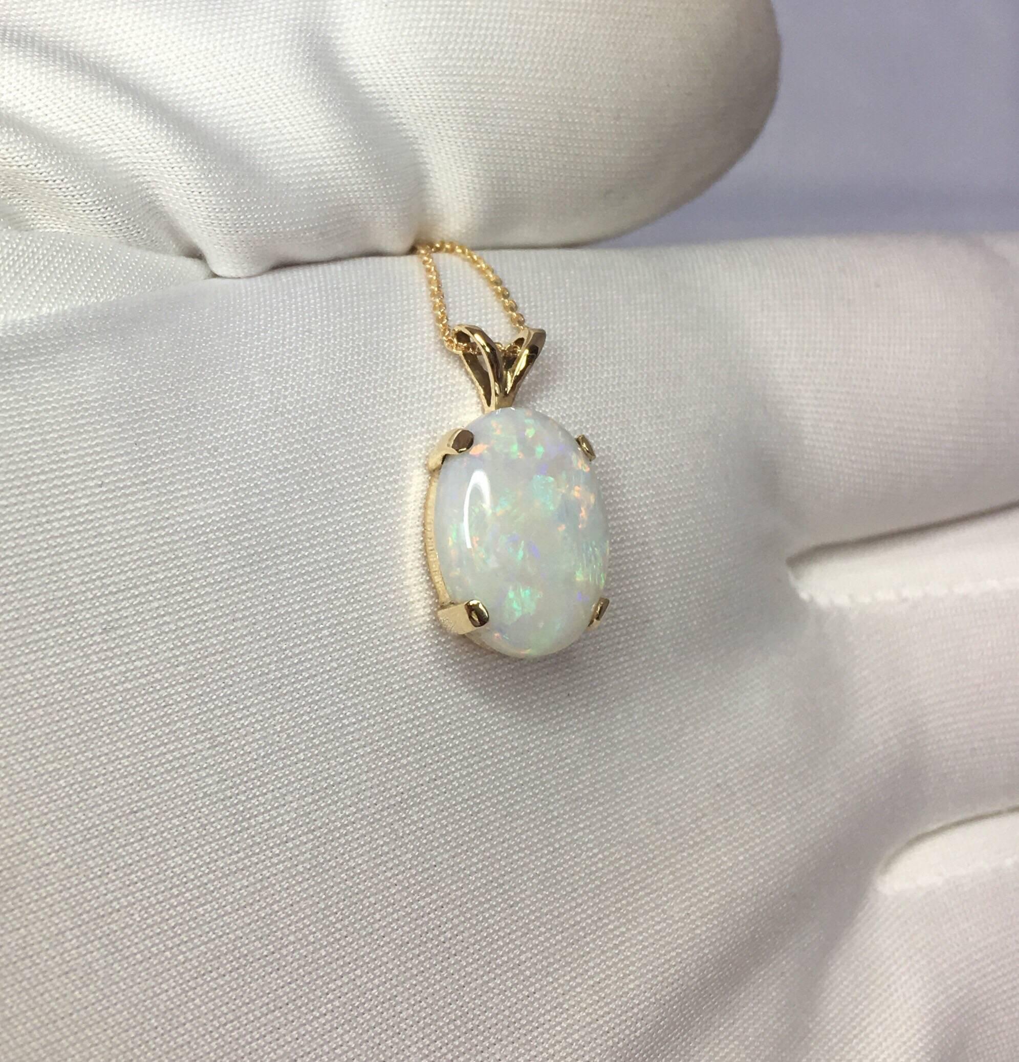 Beautiful fine Cooper Pedy white opal with stunning play of colour.
Set in a fine 14k yellow gold solitaire pendant.

Stunning Australian opal with an excellent polish and lots of colour flash. Blues, greens, oranges, yellow, purple, reds... this