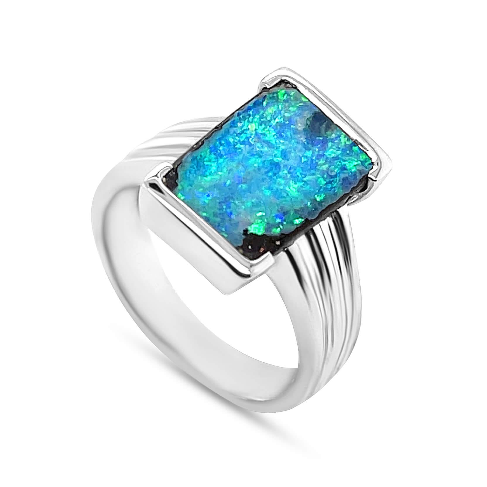 Captivating in its entirety, the 'Uncharted Seas' opal ring presents an impressive boulder opal (3.77ct) from our Jundah-Opalville mines in Queensland. The precious gemstone's colour play is reminiscent of the vast deep ocean and all its hidden