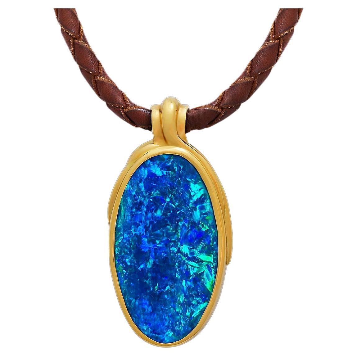 With the colours of a tropical sea, this breathtaking opal is an Australian boulder opal from outback Queensland. Surrounded by solid 18K gold, it is a true desert beauty; with over 60ct of a stunning gem-grade boulder, this is a once-in-a-lifetime