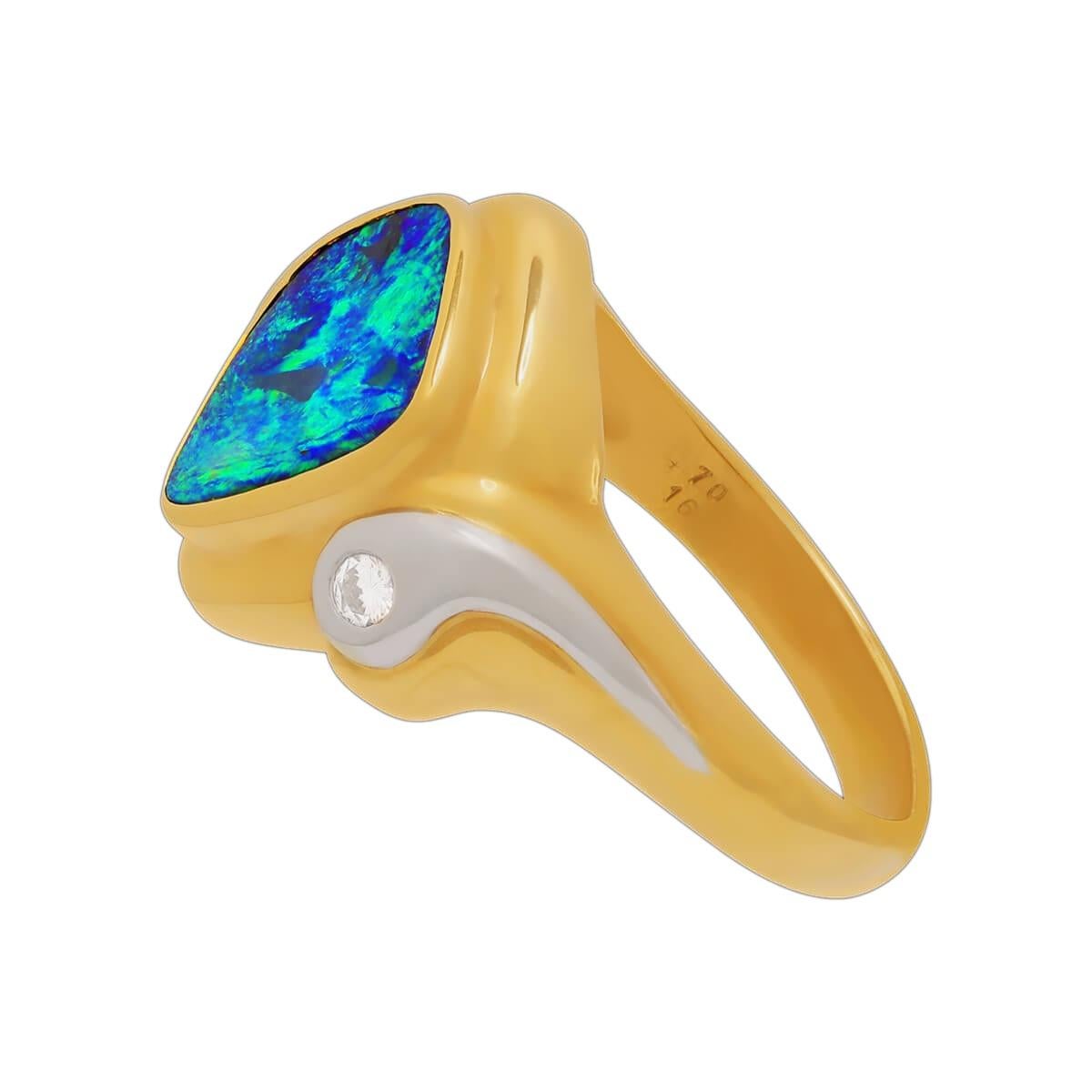 If you like your opal bright, here is one that is almost off the charts. This amazing blue-green black boulder opal is of clean, vivid colour, set in an 18K solid gold and platinum ring with high jewellery grade diamonds. The bright green flash will