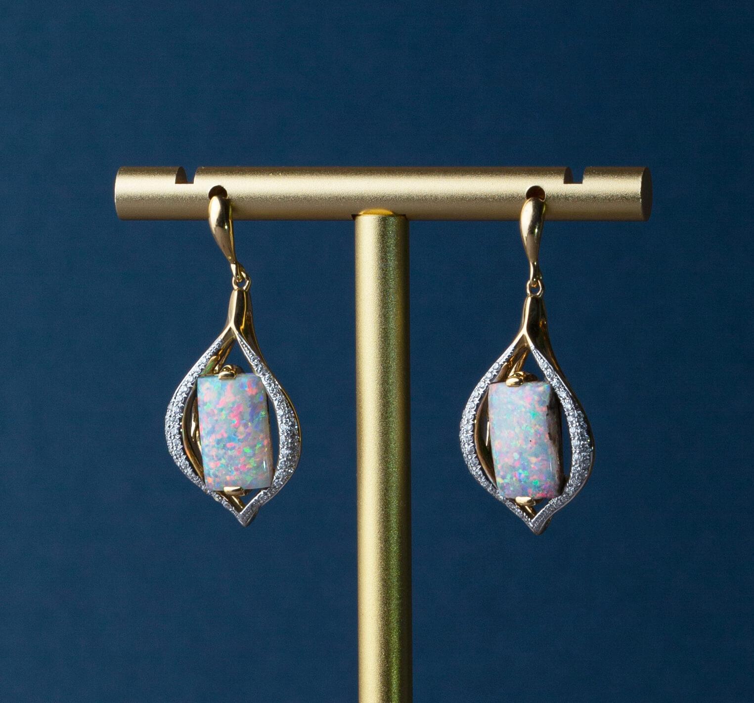 “Two Kisses” opal earrings show off natural, untreated light boulder opals (7.26ct) ethically sourced from our own mines in Jundah-Opalville, Queensland. Beautifully matched rare opals lie suspended between lines of diamonds making “Two Kisses” as