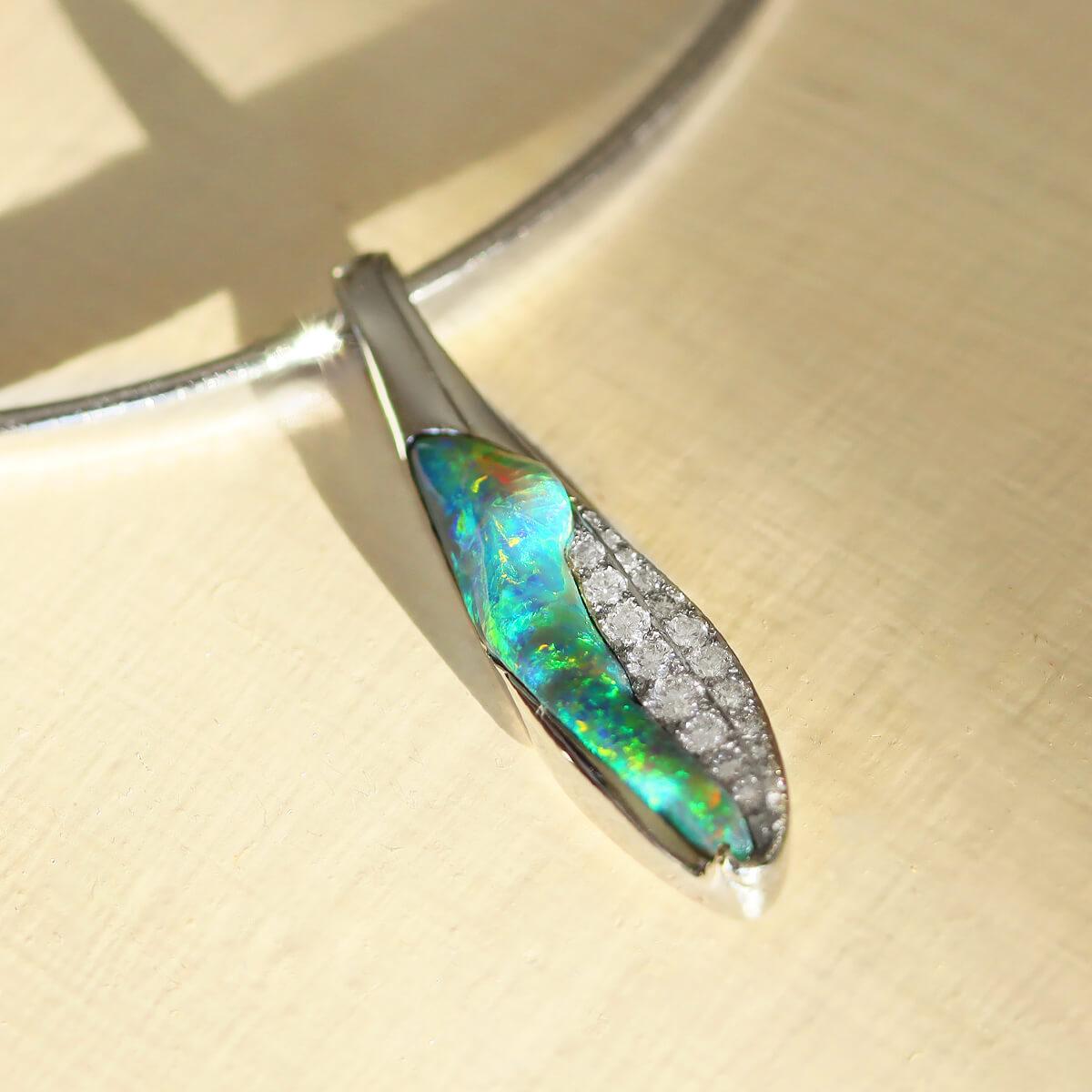 Wenn Sie auf der Suche nach etwas Einzigartigem und Schönem sind, sind Sie hier genau richtig. Mit fast einem Karat strahlend weißer Diamanten und dem wunderschönen blaugrünen schwarzen Opal ist dieser Anhänger einfach atemberaubend. Stellen Sie