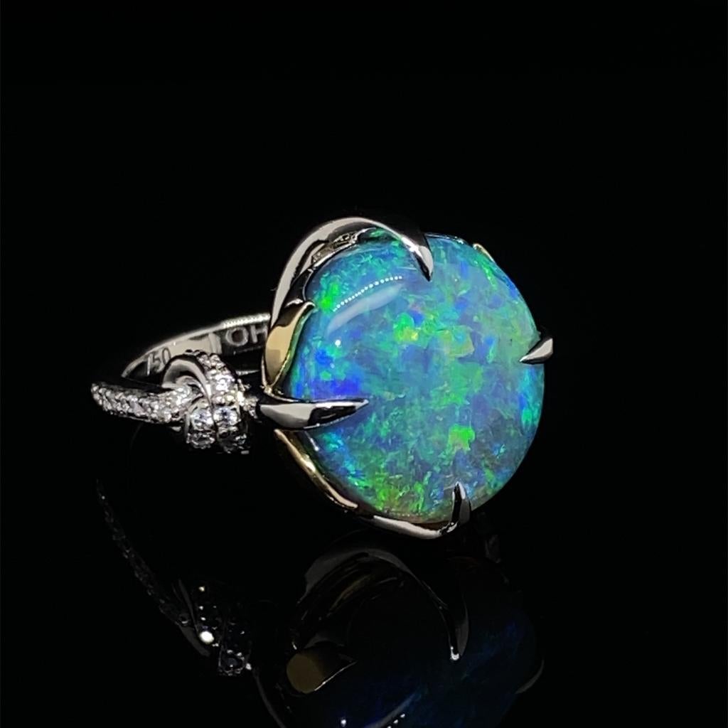 Hand made platinum and 18ct yellow gold one of a kind ring featuring the most exquisite Australian Black Opal. Set with high quality E/Fsi diamonds down the band.

Opal is solid and wieghs 8.10ct

Round Opal, blue / green flec with a flash of orange