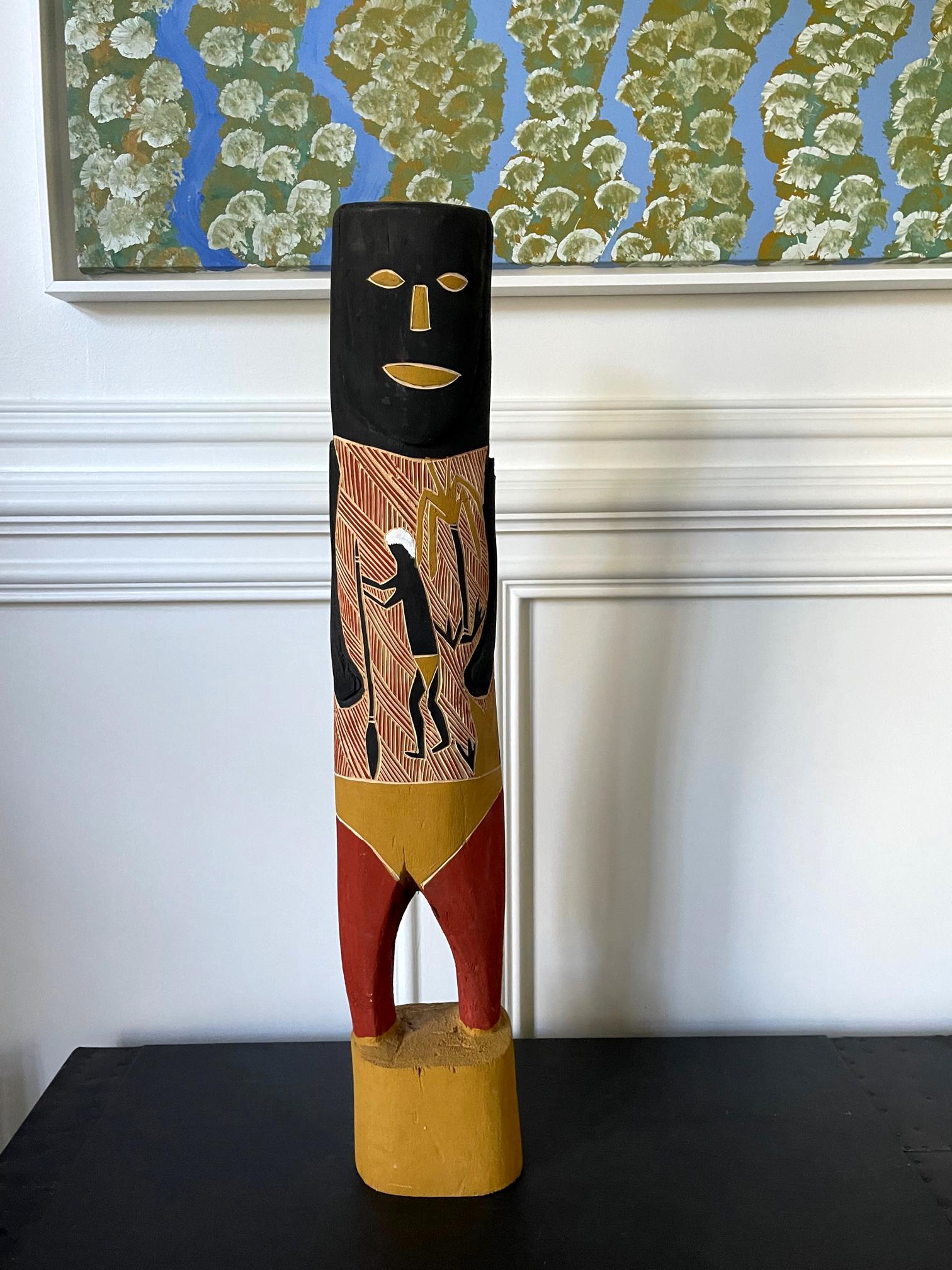 Hand-carved wood ancestor figure with surface pictorial carving showing kangaroo hunting and decorated with black and red paint and white and yellow ocher pigment. The figure slightly leans forward as made. 
The piece was carved by aboriginal