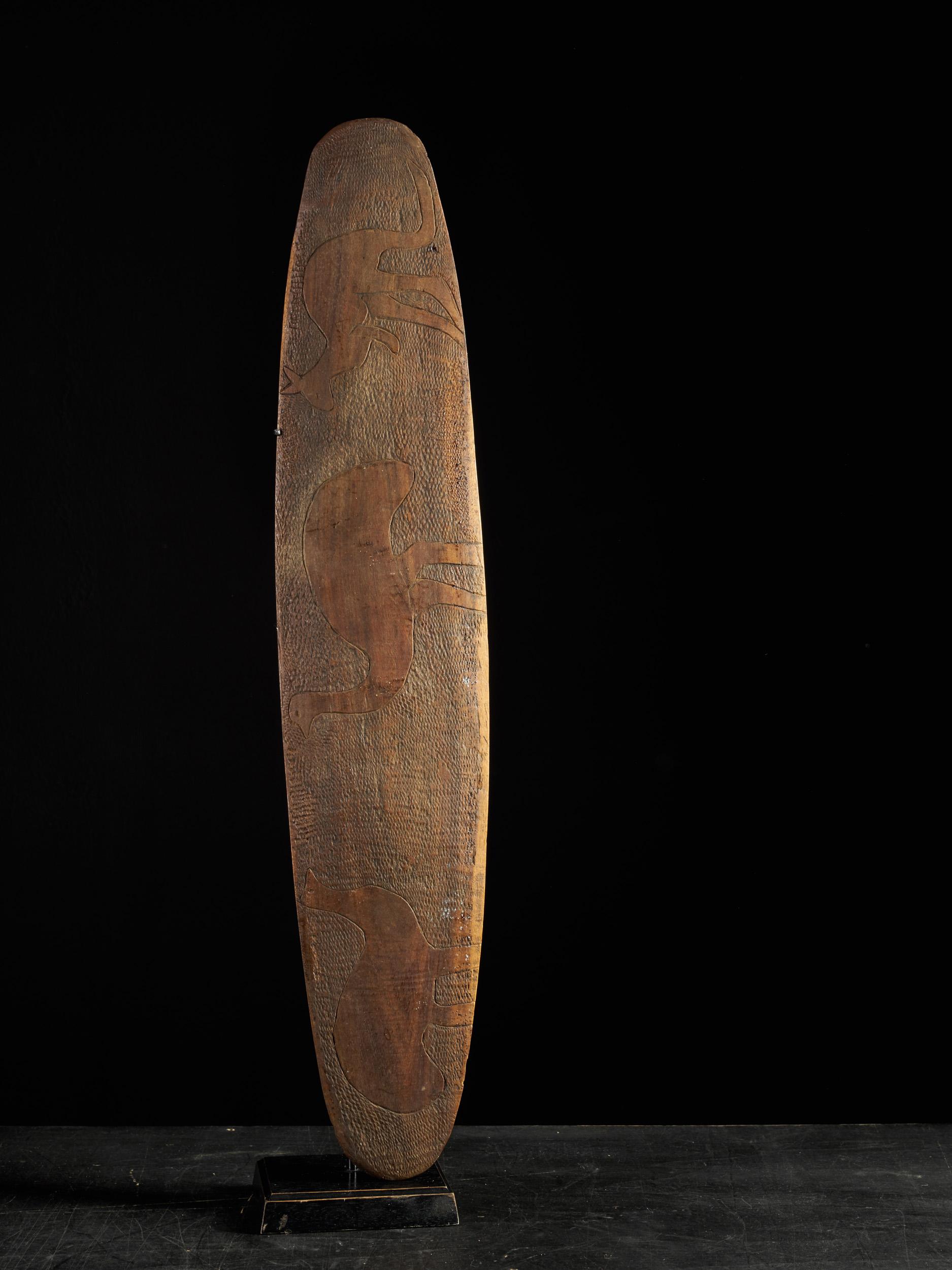 This Aboriginal Shield displays an integral handle with hand-carved emu and kangaroo.