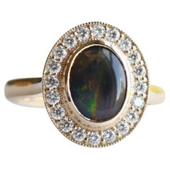 Bague en or 14 carats avec opale noire d'Australie de 188 carats et halo