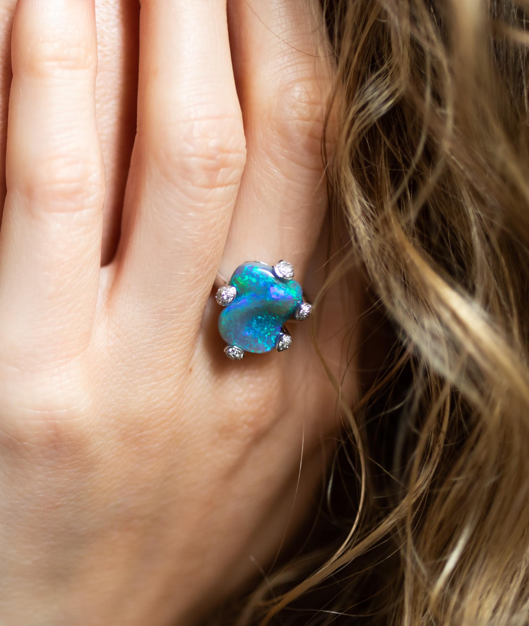Distinctive and unusual “Maiden Spring” presents a carved black opal (2.36ct) from Lightning Ridge cradled by minute hands of 18K white gold and shimmering diamonds. This expertly crafted opal ring is a celebration of love, beauty and joy. Designed