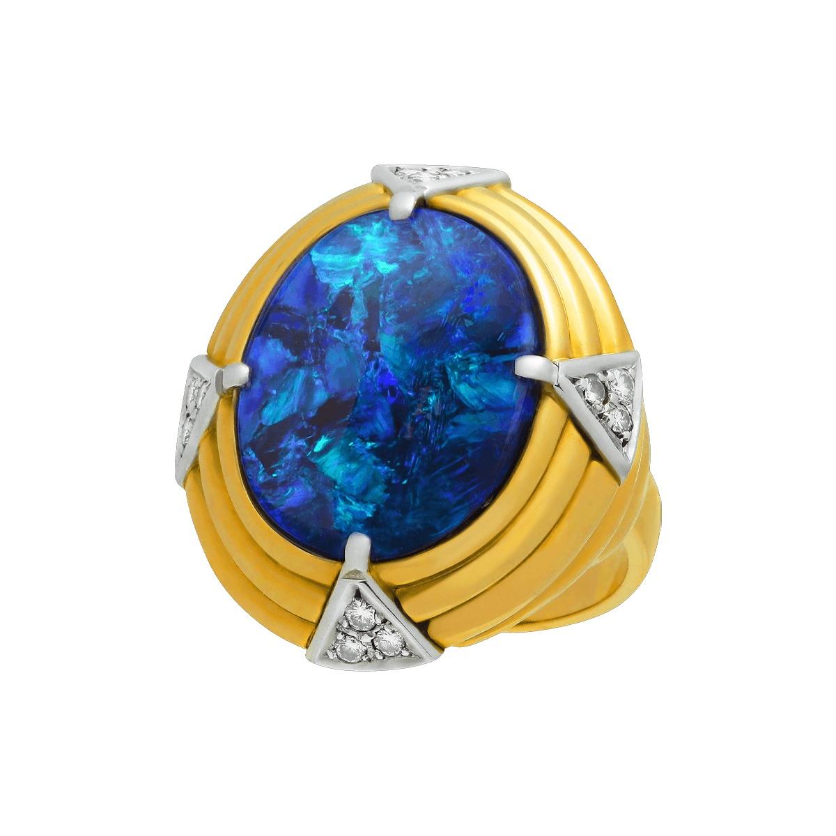 A classic beauty from a bygone era. This magnificent black opal with its deep mysterious blues heralds from a design era when class and sophistication meant everything. Old world charm in this statement piece. Solid 18K gold with platinum accents