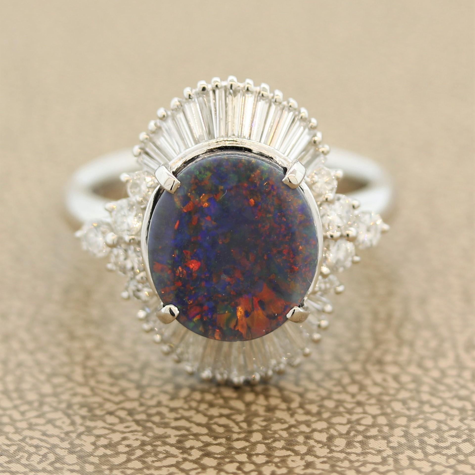 A classic Australian black opal with bright flashes of color! This black opal, most likely from Lightning Ridge in Australia, weighs 2.57 carats and has fine play-of-color, mainly reds and oranges with some blues and purples. It is surrounded by