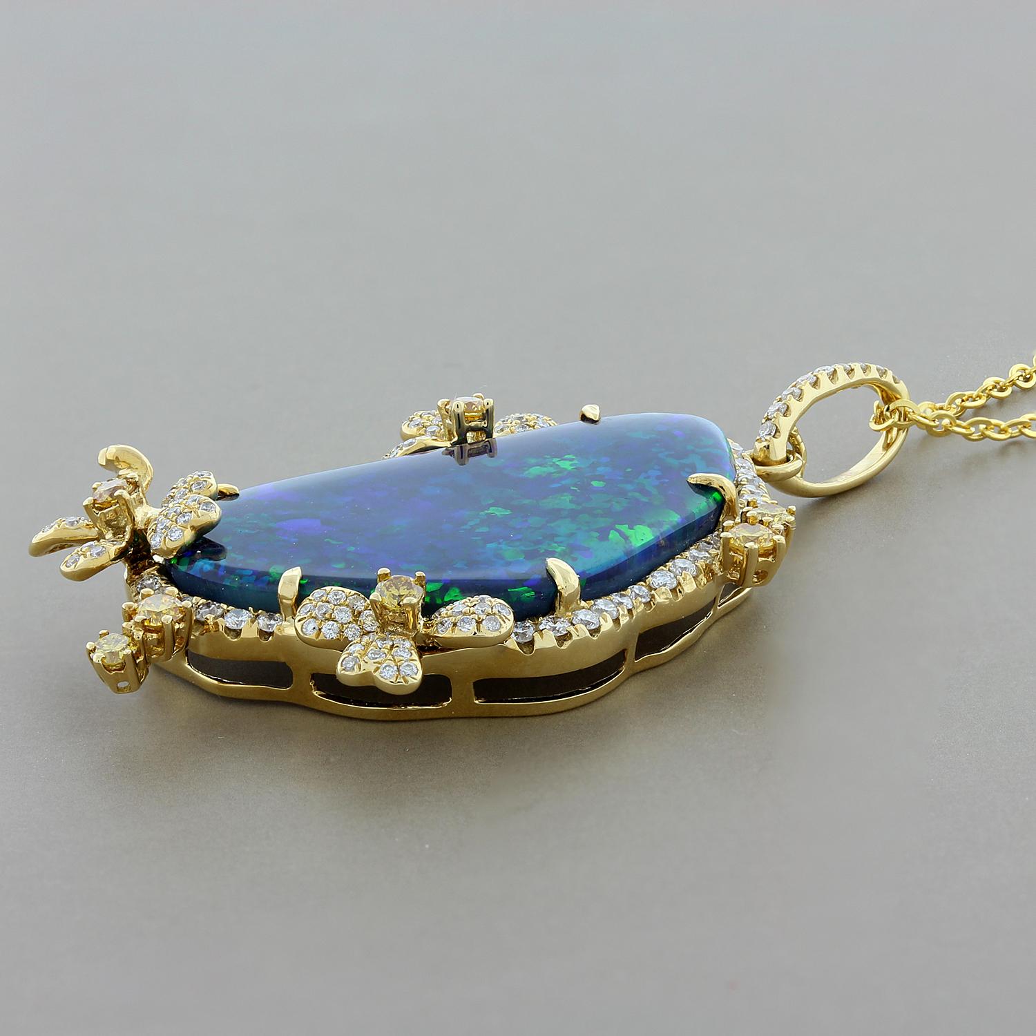This grand pendant features a rare Australian black opal weighing 15.32 carats with strong play of color and flashes of blue and green. There are 1.14 carats of fancy yellow and white diamonds surrounding the black opal set in 18K yellow gold floral