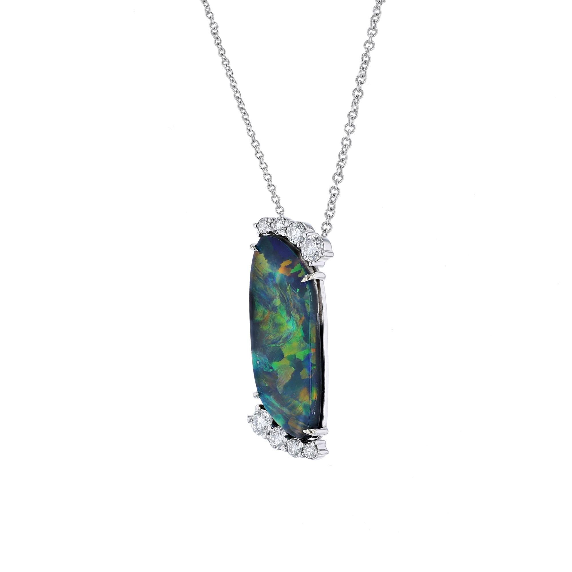 This 14K white gold necklace features an iridescent Australian Black opal weighing 4.13 carats. Surrounded by 8 round cut, prong set diamonds weighing 0.47 carat. WIth a color grade (G) and clarity grade (VS). All stones are prong set. 