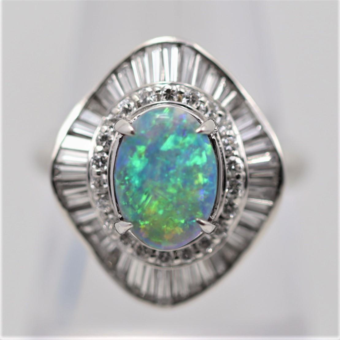 An exceptional natural Australian black opal weighing 1.99 carats takes center stage! It has fantastic play-of-color and bright strong flashes of greens, blues, oranges, and yellows dance across the stone as it is tilted. It is accented by 1.27