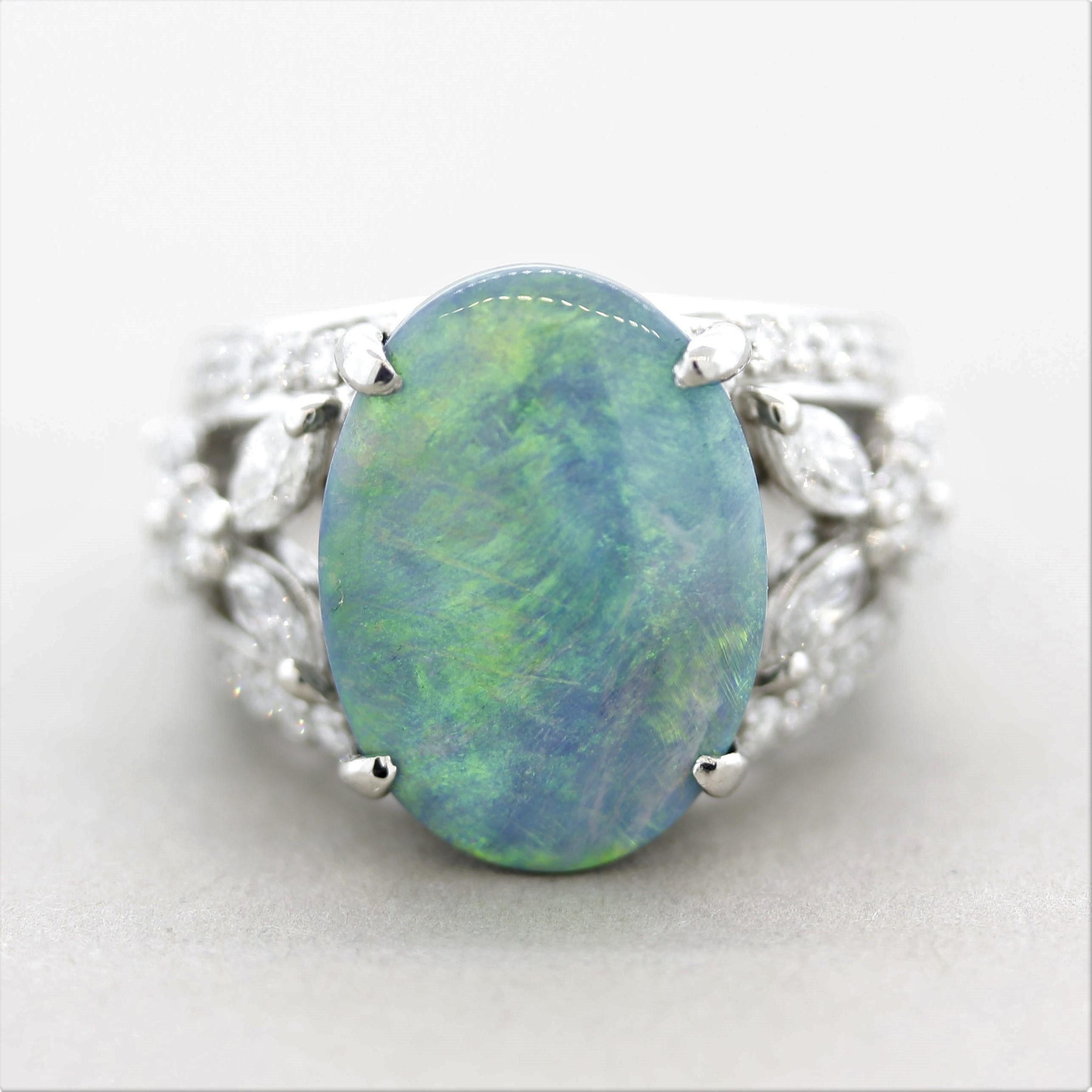 A large and impressive Australian black opal ring! The opal weighs 6.32 carats and has excellent play-of-color as bright flashes of colors can be seen across the stone. Predominantly greens with yellows, blues, and orangy-reds. It is accented by