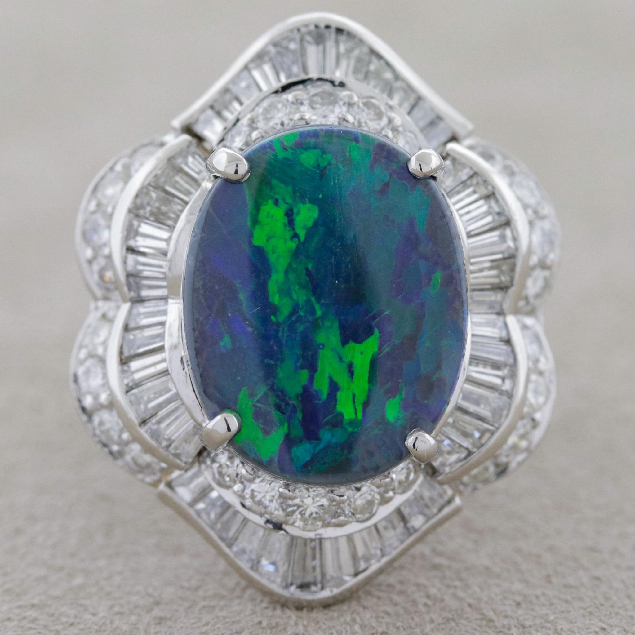 A large and impressive cocktail ring featuring a fine and gemmy Australian black opal! The opal weighs 5.80 carats and has excellent play-of-color and large prominent bright flashes of green and blue emanate from the stones surface. It is accented