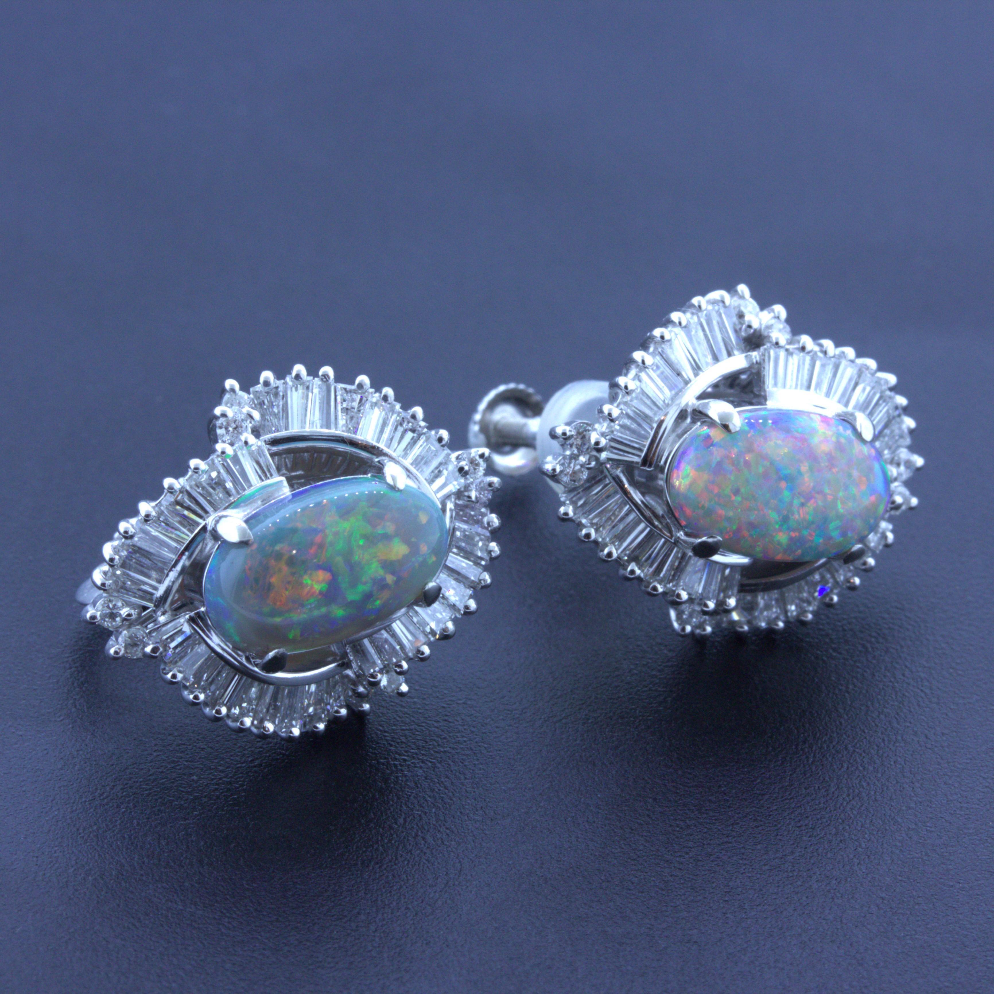 A sweet and stylish pair of Australian black opal earrings. The opals weigh a total of 3.72 carats and have great play-of-color as flashes of red, green, blue, yellow and orange can be seen across the two stones. They are complemented by 1.73 carats
