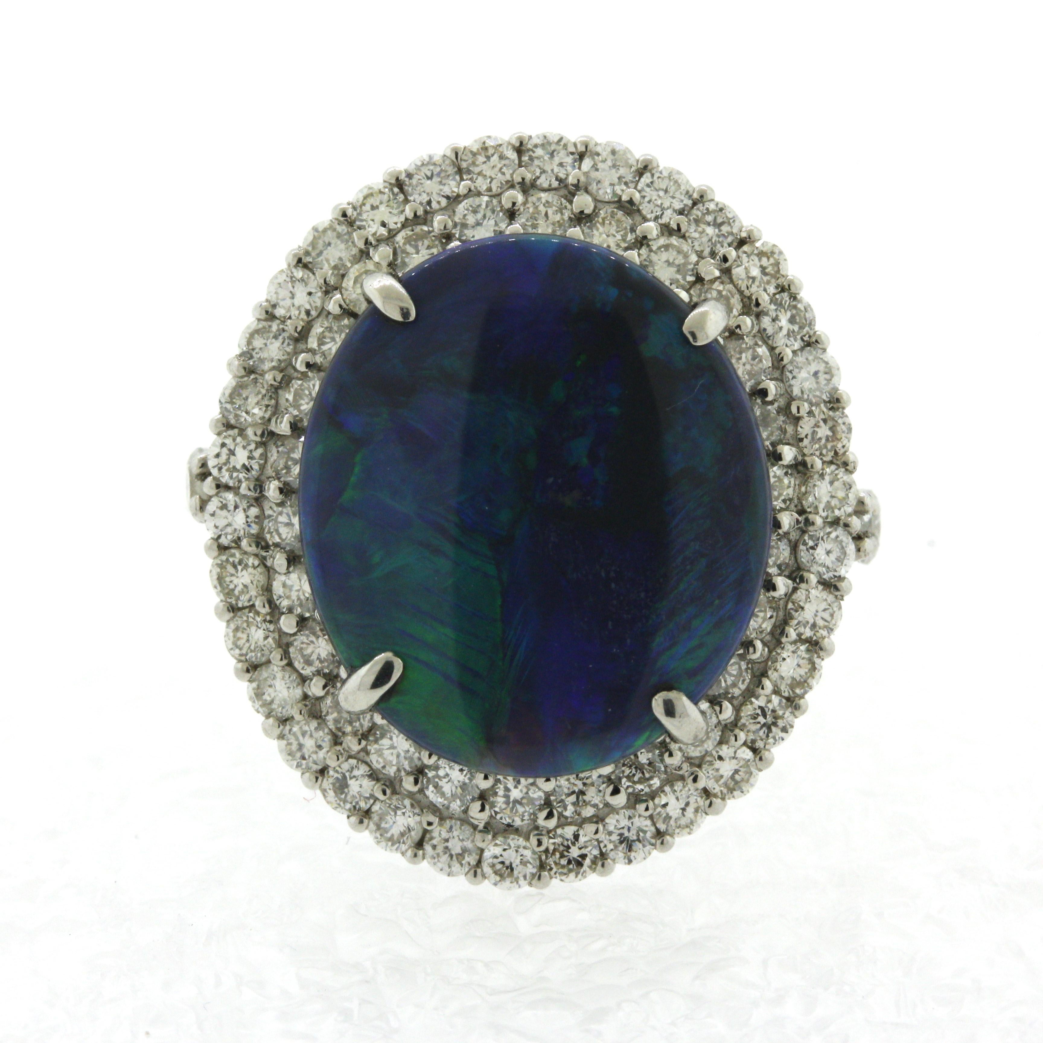 A classic black opal from Australia with a beautiful blue-green play of color. The opal weighs 2.01 carats and has a deep black body color allowing the flashes of blue and green to shine bright and contrast with the body. It is complemented by 1.63