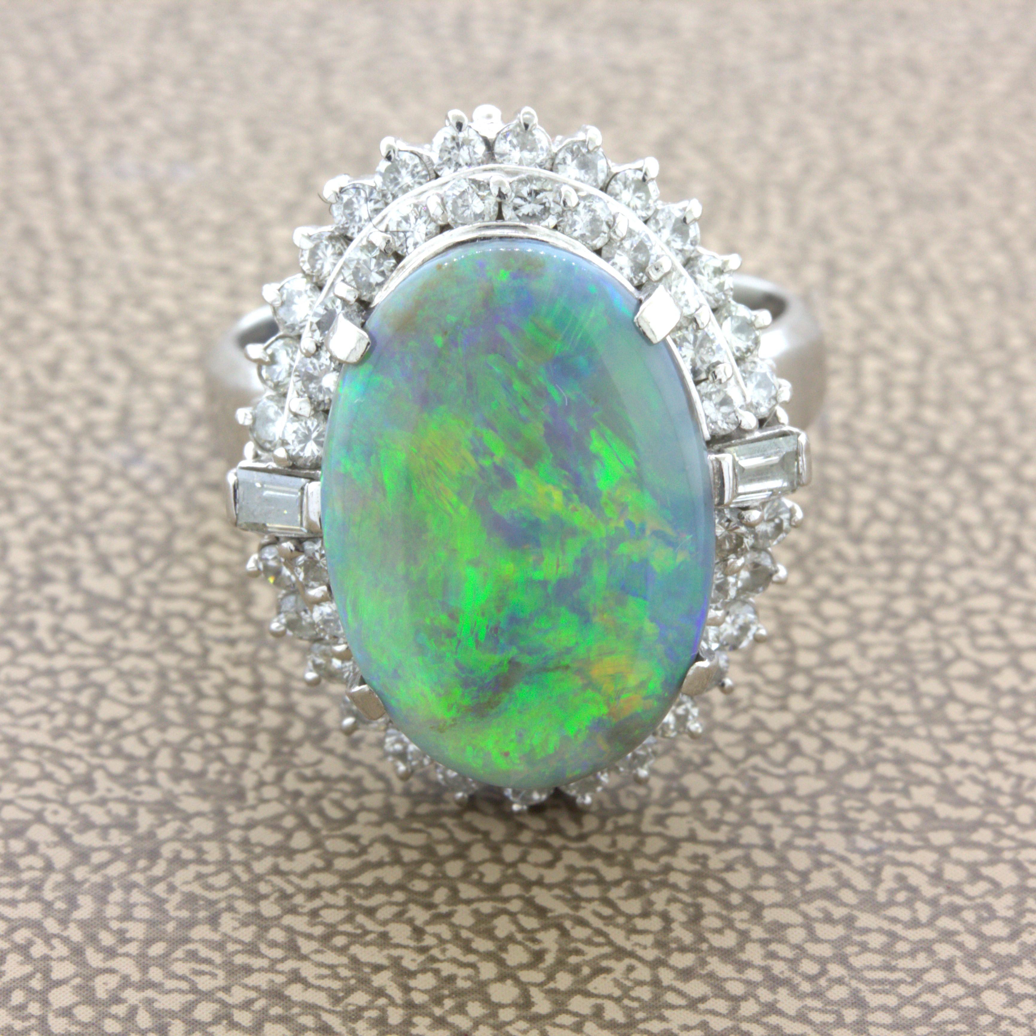 A chic and elegant ring featuring a natural Australian black opal. It weighs 4.10 carats and has very good play-of-color as flashes of orange, green, yellow, and blue can be seen as the stone is moved in the light. It is complemented by 1.10 carats