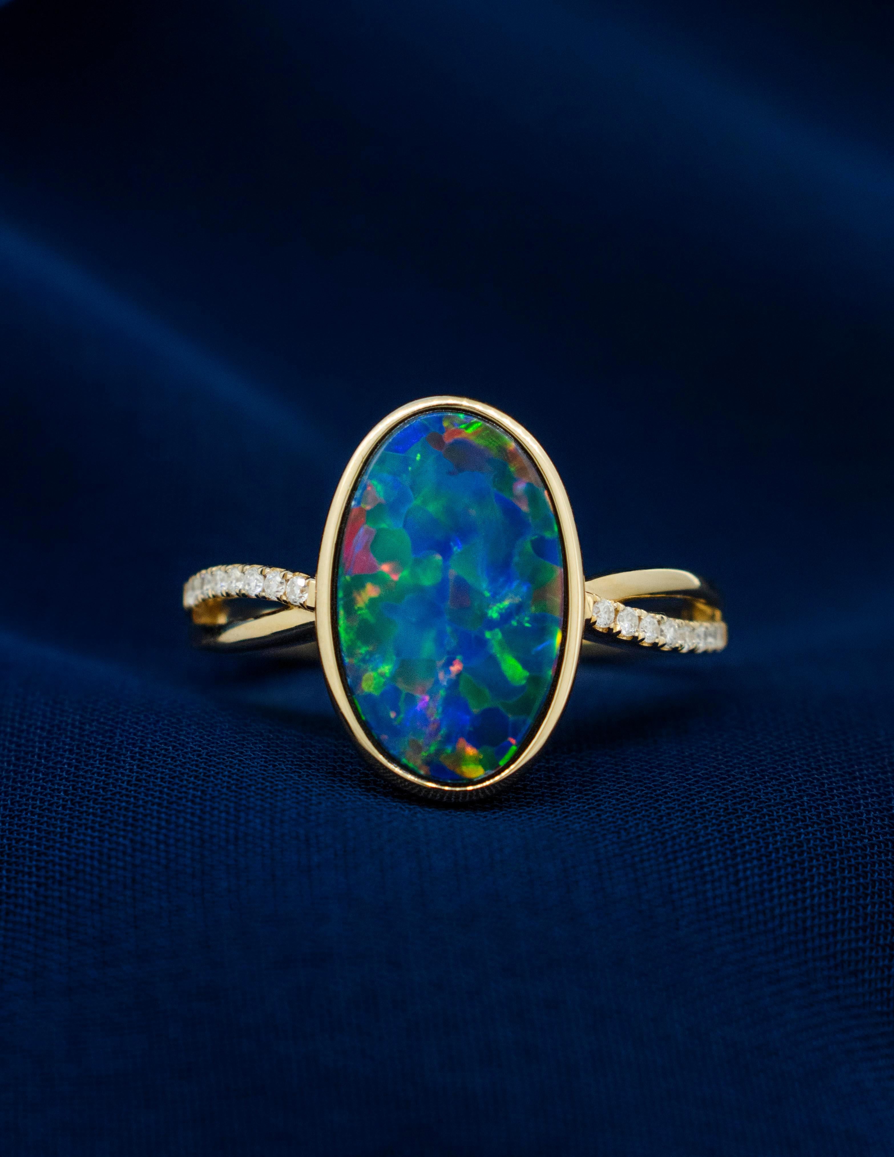 Modern Australian Black Opal Ring with Diamonds made of 14 karat Yellow Gold For Sale